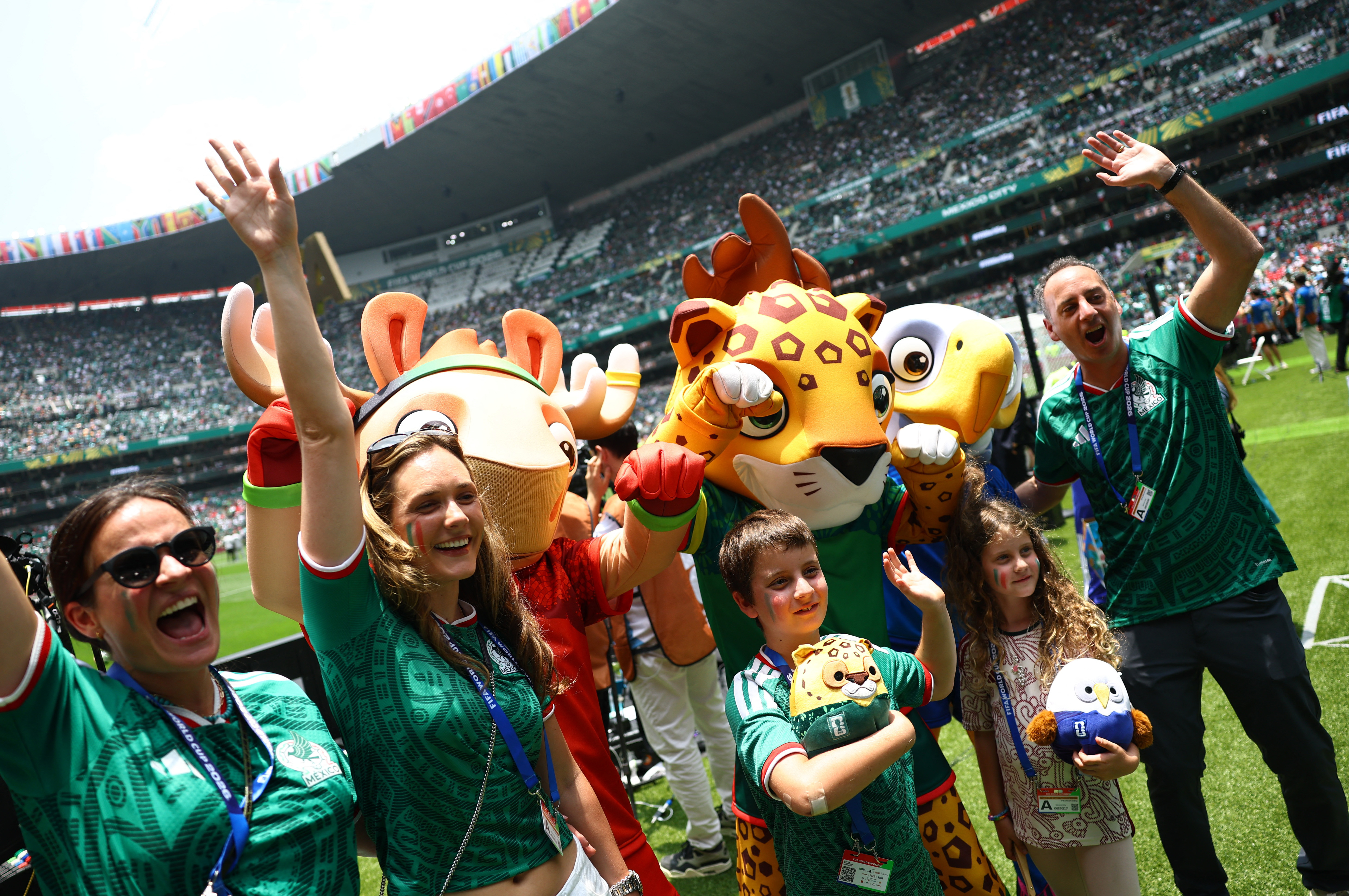Soccer Football - FIFA World Cup 2026 - Group A - Mexico v South Africa - Estadio Azteca, Mexico City, Mexico - June 11, 2026 Mexico fans pose for a photo with the FIFA World Cup 2026 mascots Maple, Zayu, and Clutch before the match REUTERS/Kai Pfaffenbac
