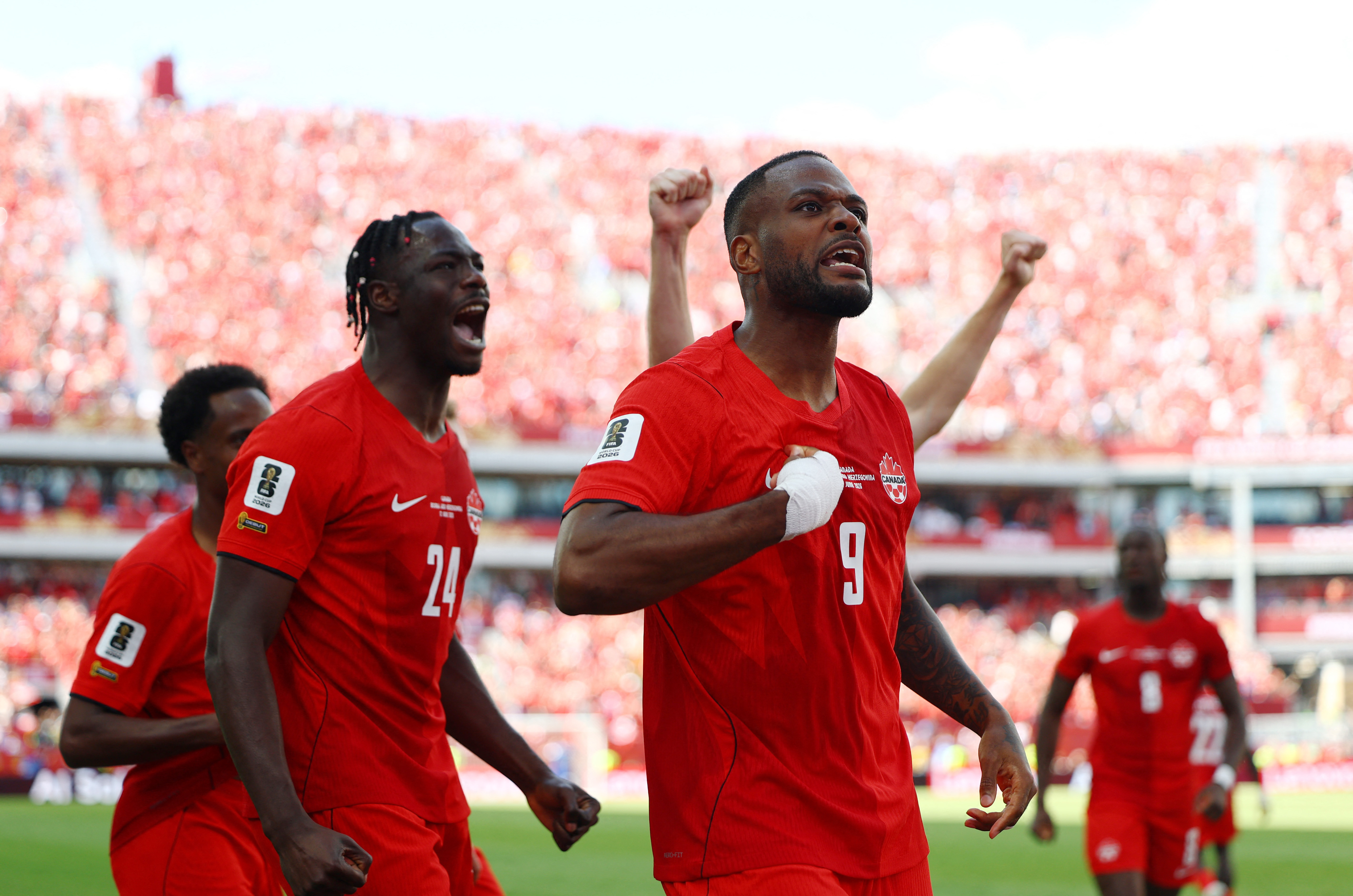 Soccer Football - FIFA World Cup 2026 - Group B - Canada v Bosnia and Herzegovina - Toronto Stadium, Toronto, Canada - June 12, 2026 Canada's Cyle Larin celebrates scoring their first goal with Promise David REUTERS/Claudia Greco