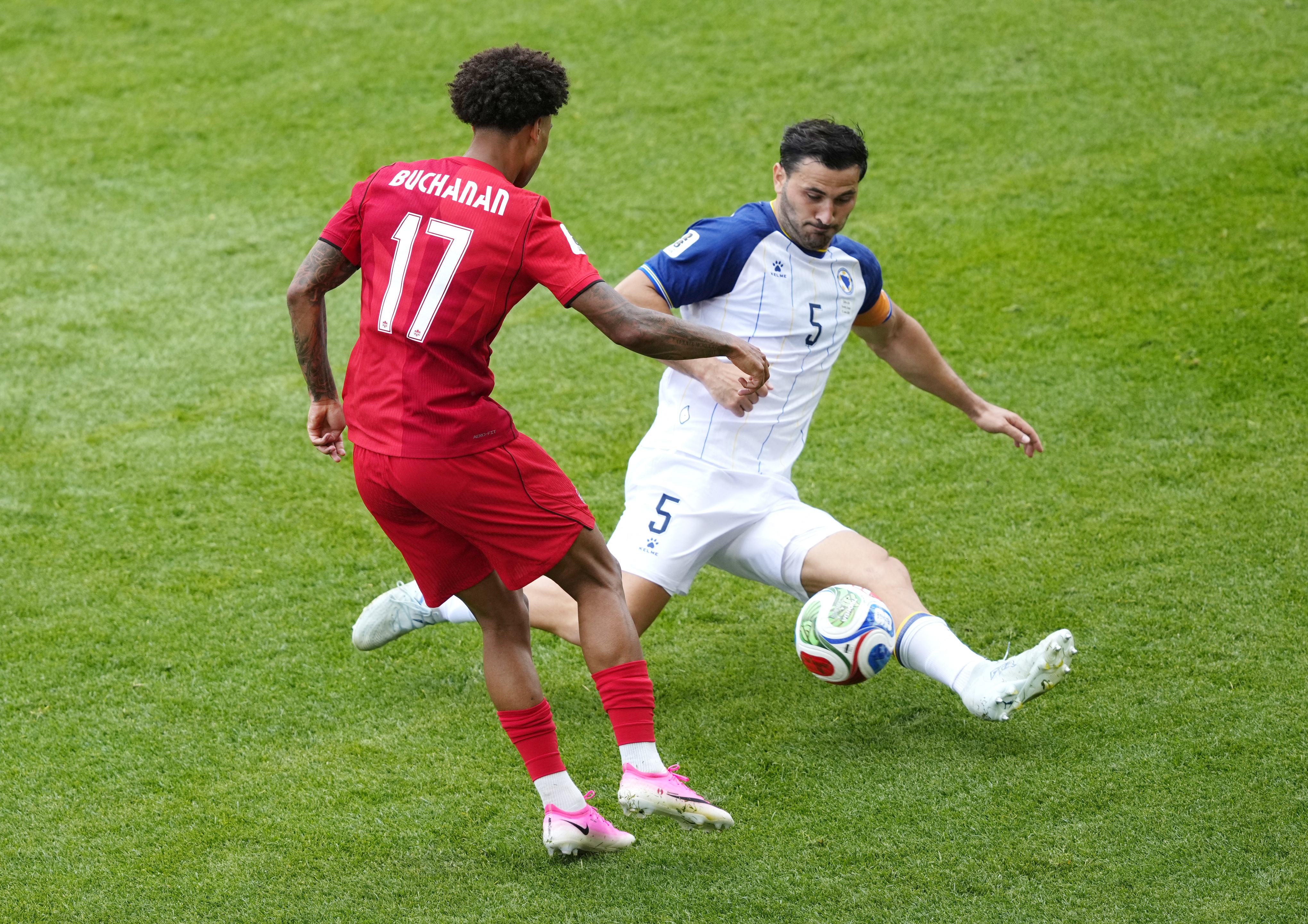 Soccer Football - FIFA World Cup 2026 - Group B - Canada v Bosnia and Herzegovina - Toronto Stadium, Toronto, Canada - June 12, 2026 Canada's Tajon Buchanan in action with Bosnia and Herzegovina's Sead Kolasinac IMAGN IMAGES via Reuters/Kevin Sousa