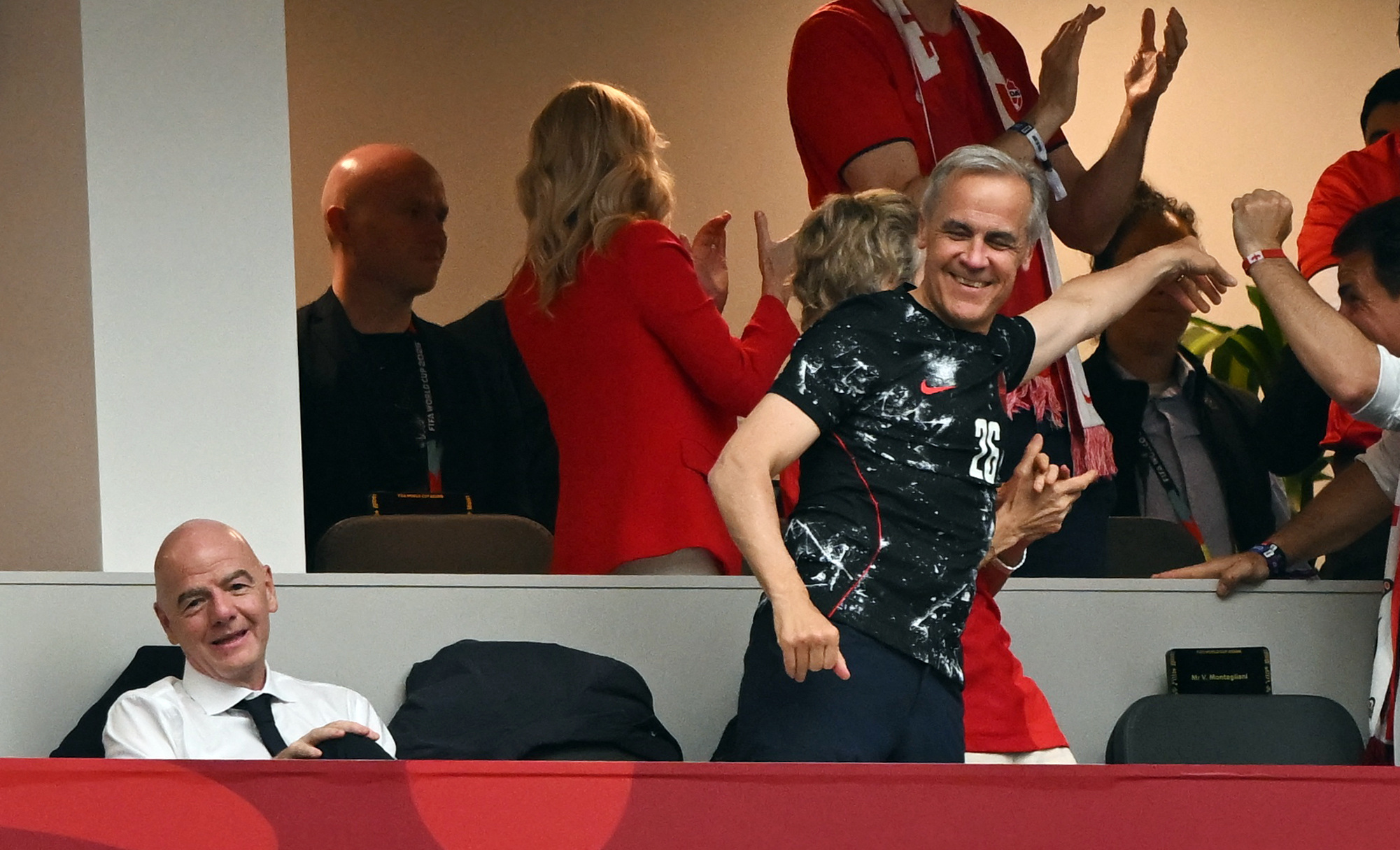 Soccer Football - FIFA World Cup 2026 - Group B - Canada v Qatar - BC Place, Vancouver, Canada - June 18, 2026 Canada's Prime Minister Mark Carney and his wife Diana Fox Carney celebrate after Jonathan David scores their third goal as FIFA President Giann
