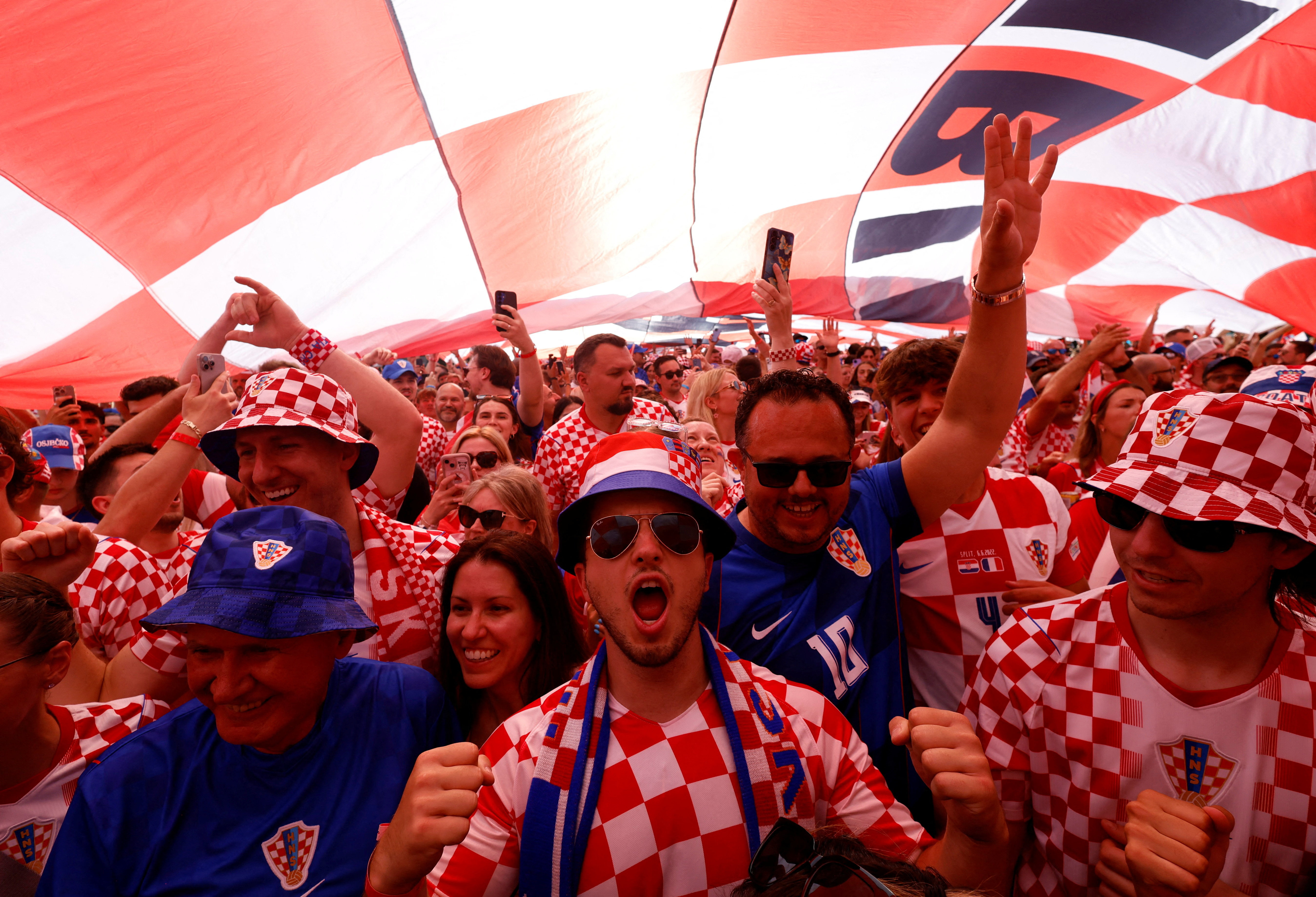 Soccer Football - FIFA World Cup 2026 - Group L - Panama v Croatia - Fans march to Toronto Stadium - Toronto, Canada - June 23, 2026 Croatia fans underneath a giant flag during the march to Toronto Stadium ahead of the match REUTERS/Carlos Osorio     TPX