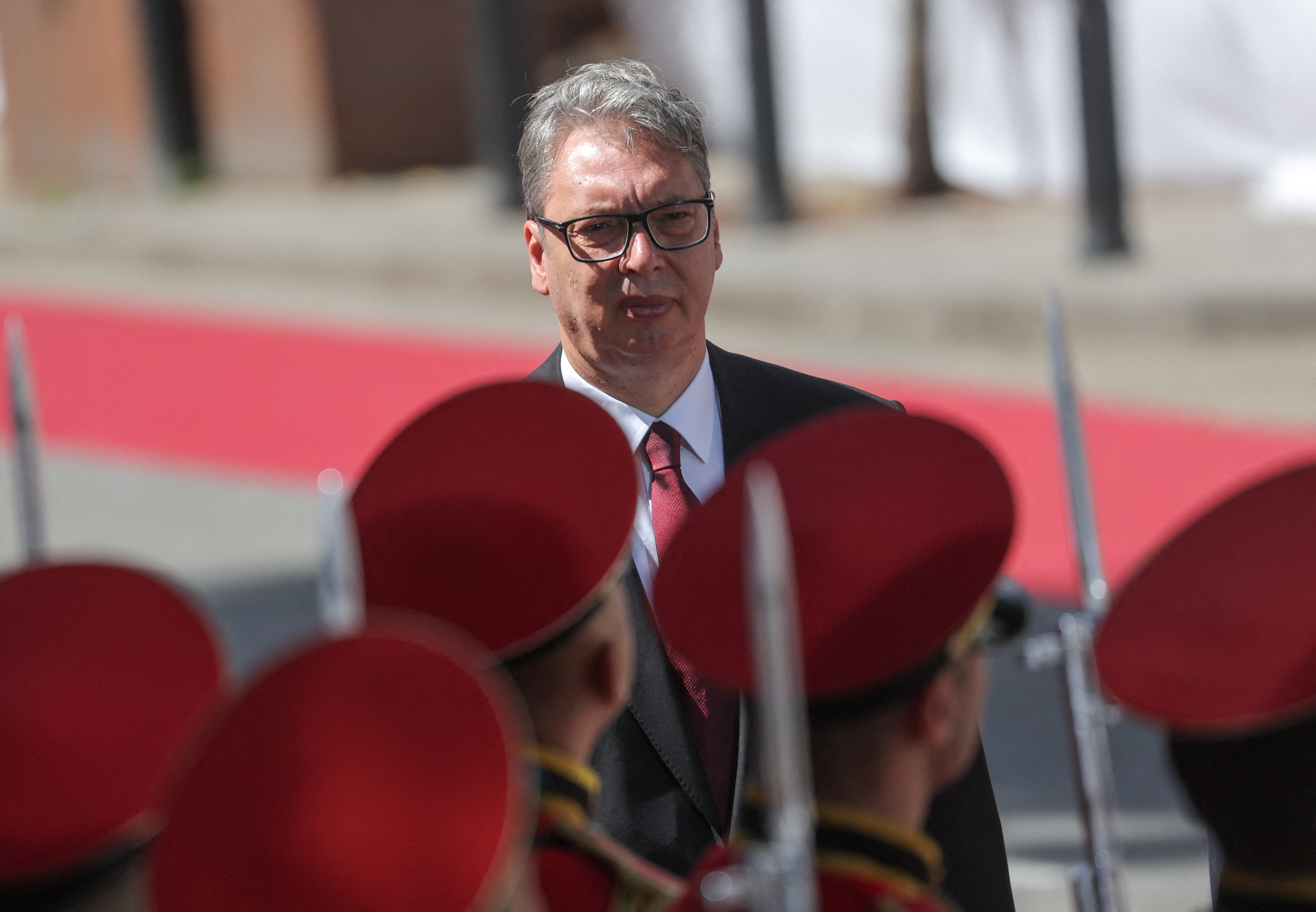 Serbian President Aleksandar Vucic walks