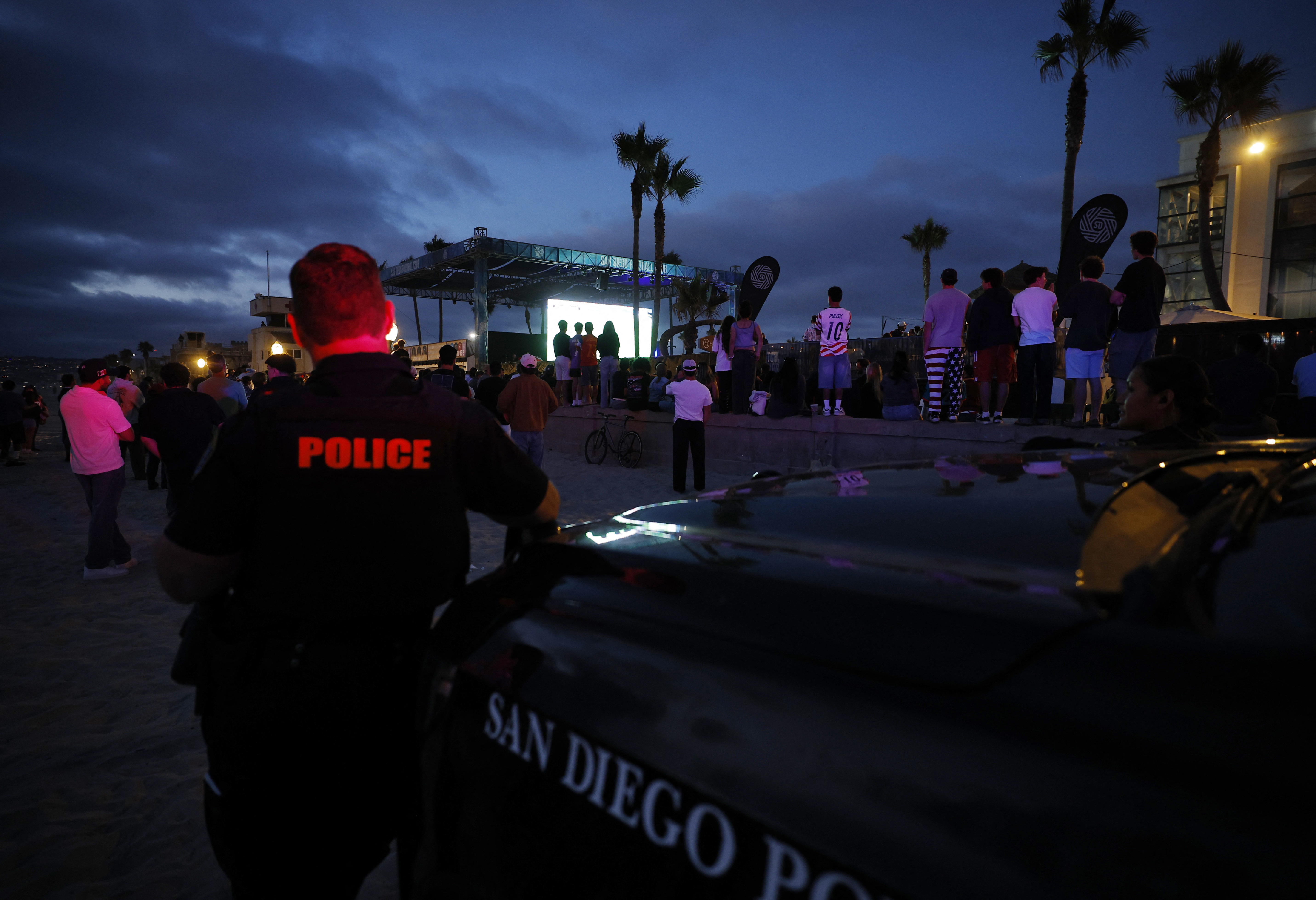 Soccer Football - FIFA World Cup 2026 - Group D - Turkey v United States - Fans gather in San Diego - San Diego, California, U.S. - June 25, 2026 A police officer looks on as fans watch the match on a big screen REUTERS/Mike Blake
