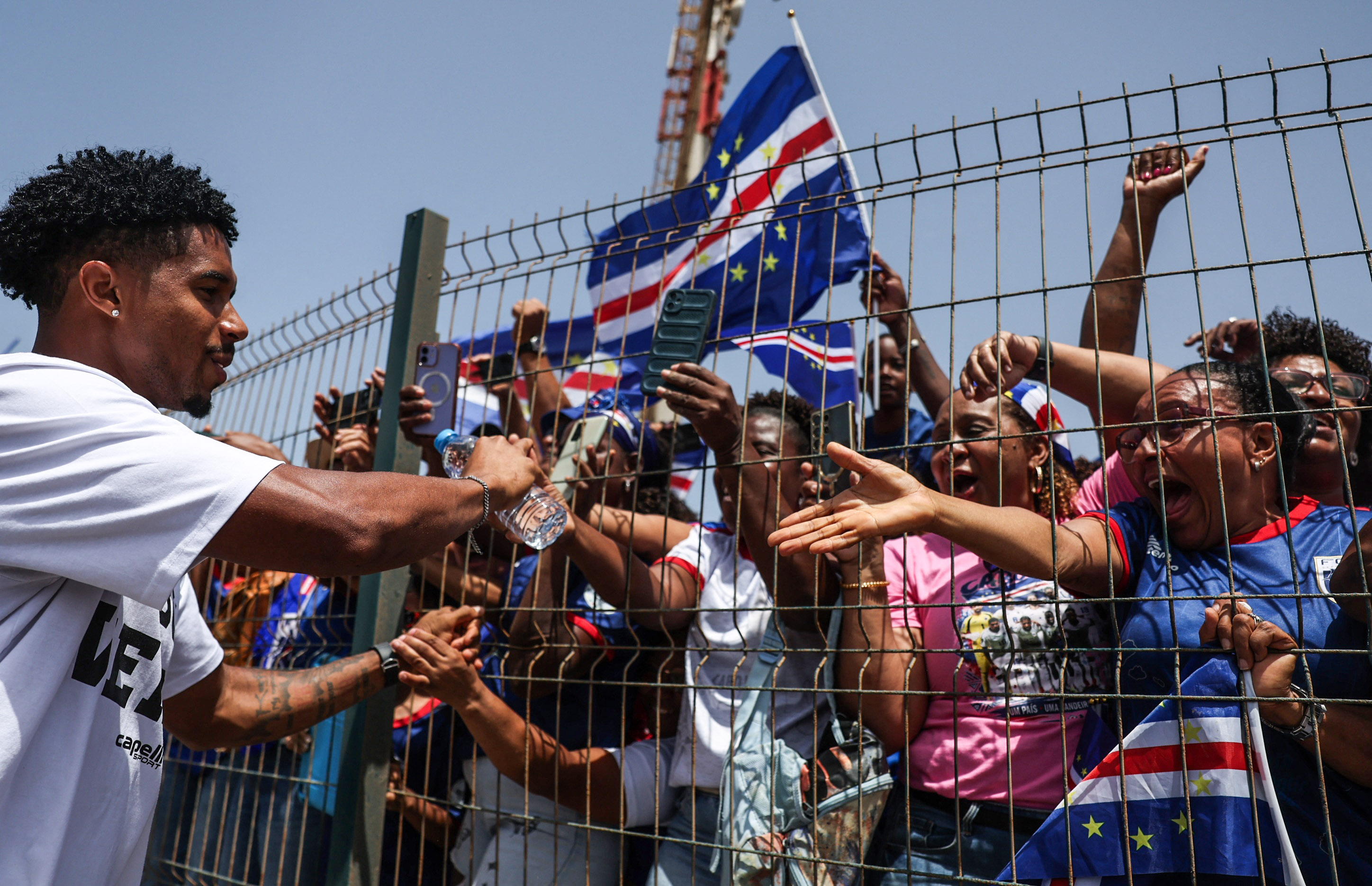 Soccer Football - FIFA World Cup 2026 - Cape Verde arrive home in Praia - Praia, Cape Verde - July 5, 2026 Cape Verde fans greet the players as they welcome the team after they arrive from the United States REUTERS/Sodiq Adelakun
