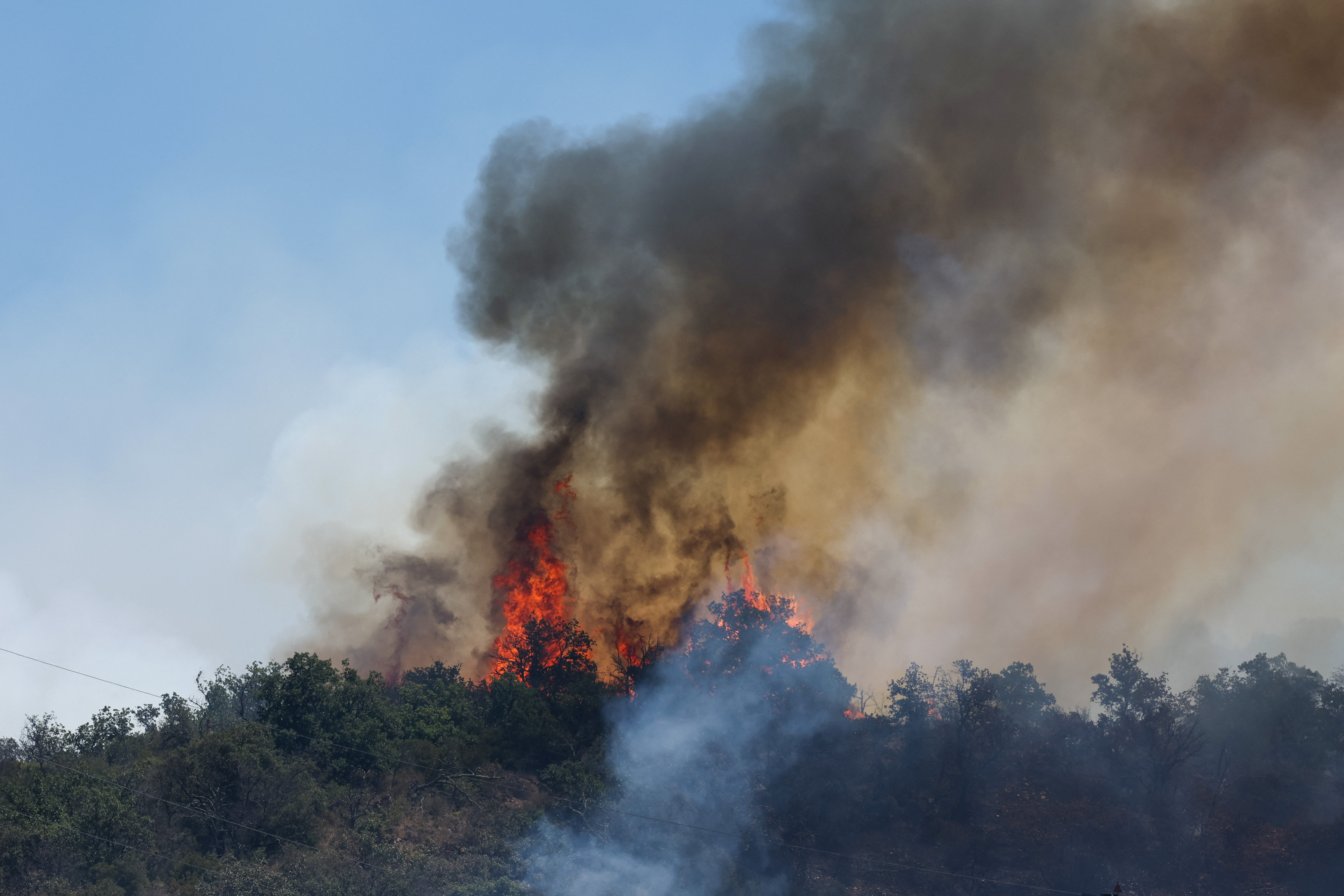 Wildfire burns in Ille-sur-Tet near Perpignan, Pyrenees-Orientales departement, France, July 6, 2026. REUTERS/Alexandre Dimou