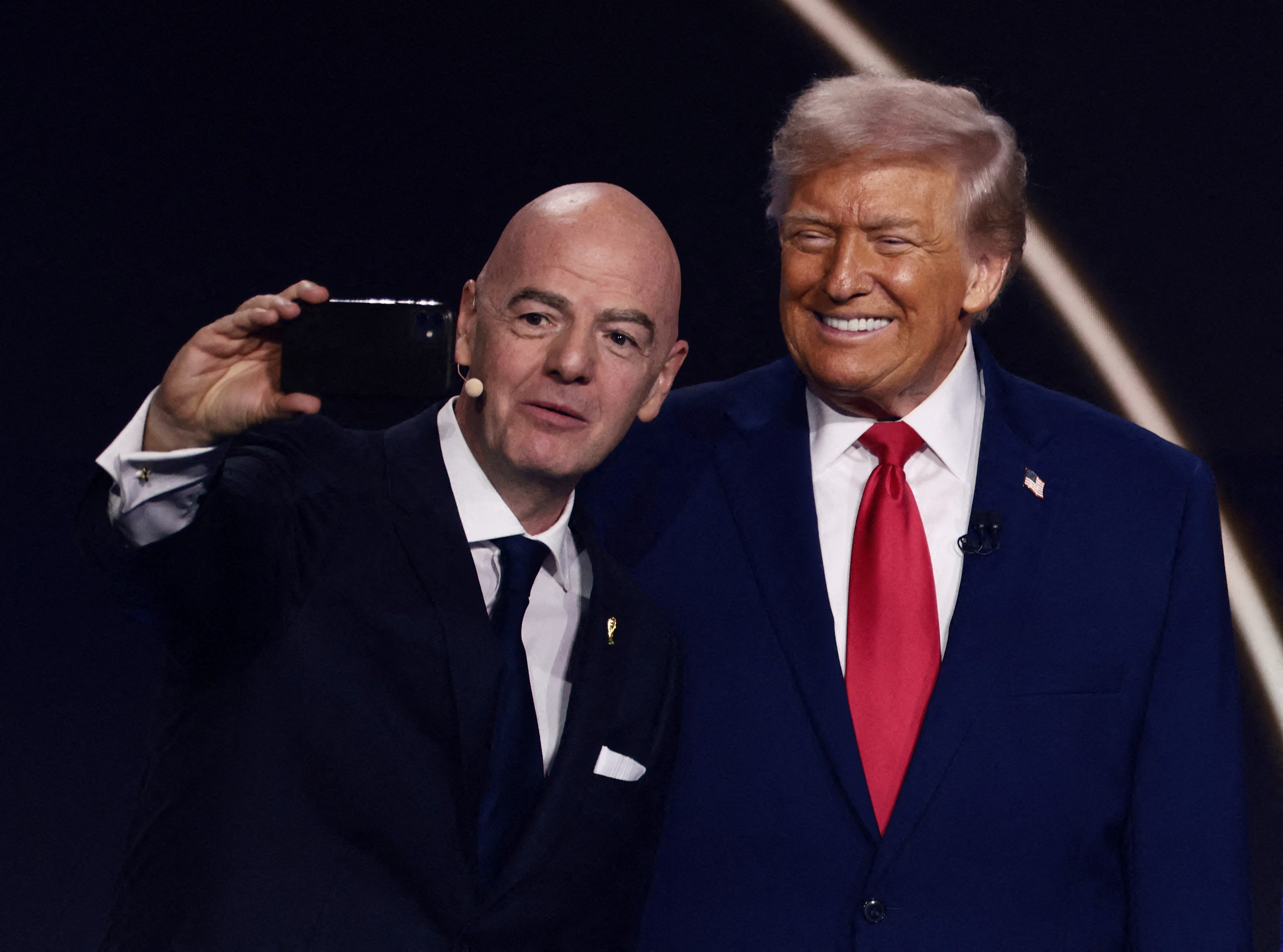 FILE PHOTO: Soccer Football - FIFA World Cup 2026 - FIFA World Cup 2026 Draw - John F. Kennedy Center for the Performing Arts, Washington, D.C., U.S. - December 5, 2025 FIFA President Gianni Infantino and U.S. President Donald Trump pose for a selfie duri
