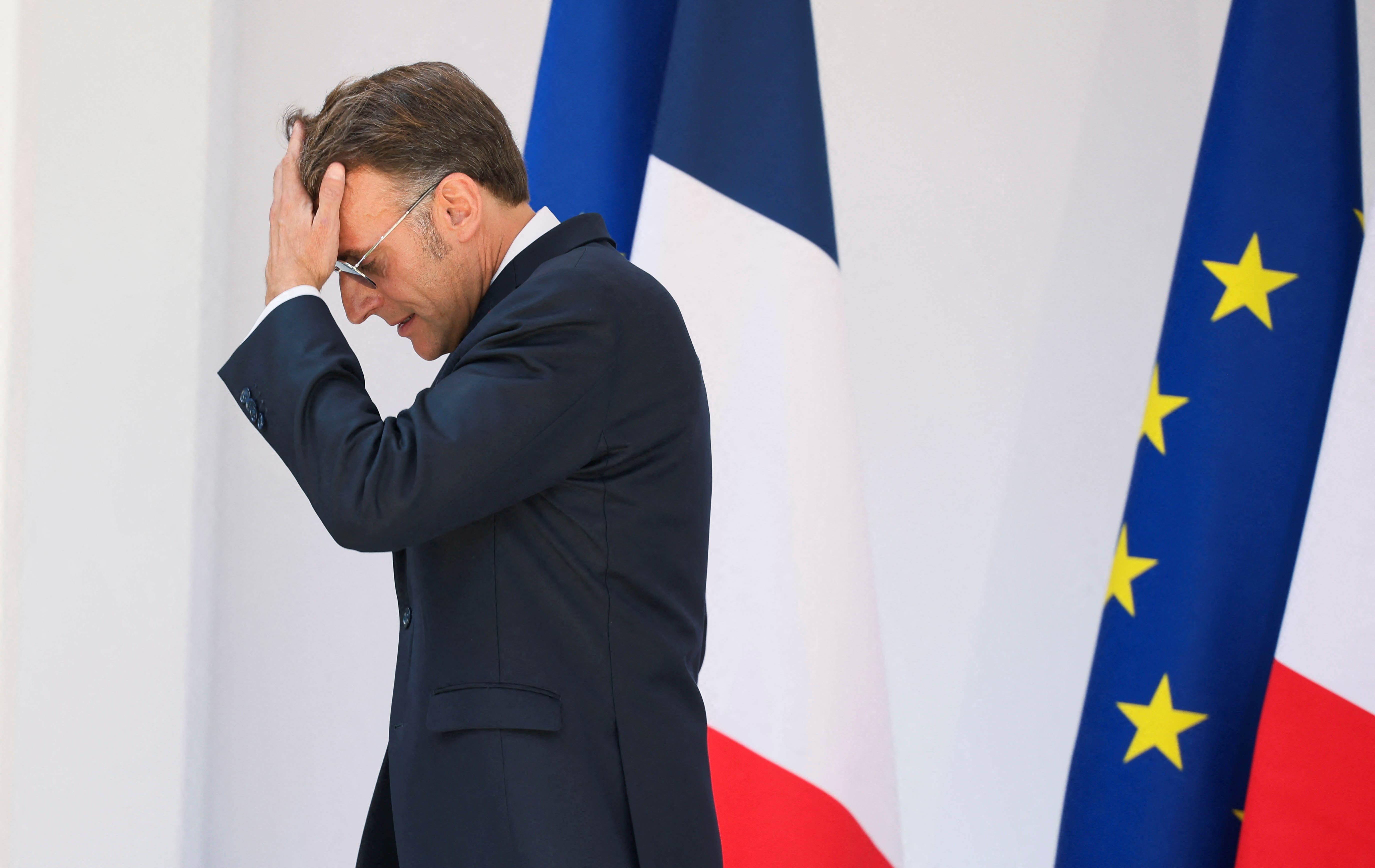 French President Emmanuel Macron walks after delivering