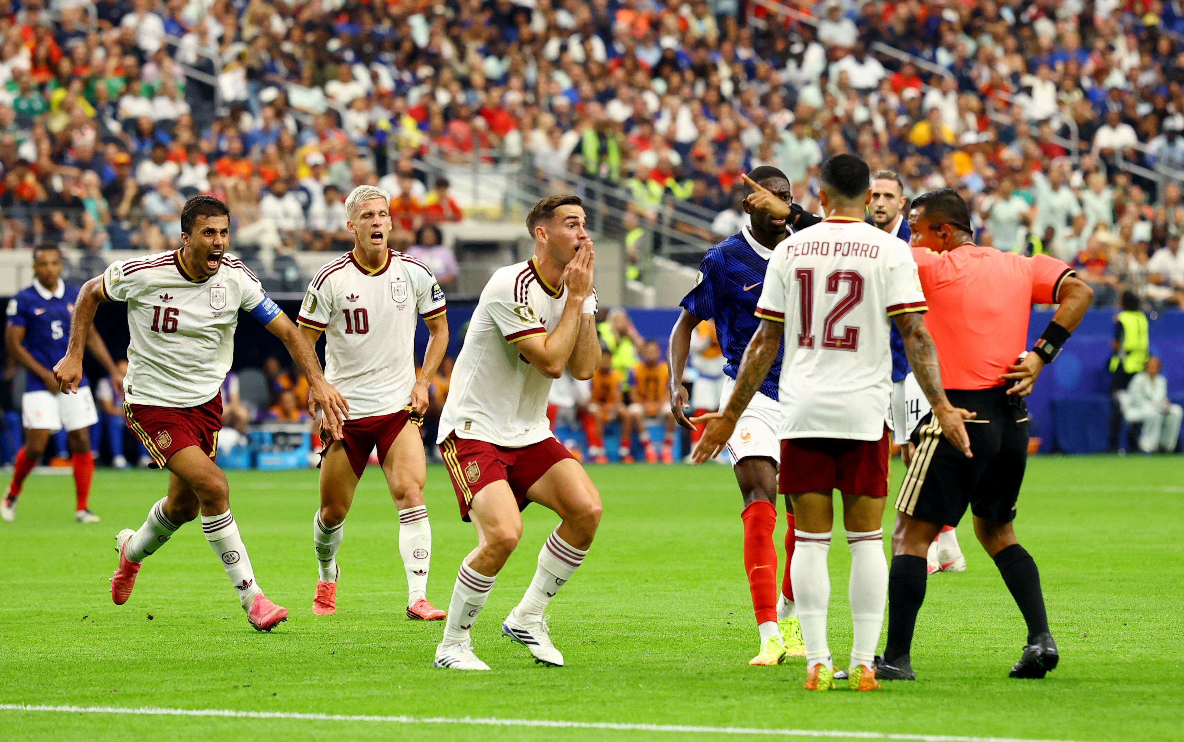 Soccer Football - FIFA World Cup 2026 - Semi Final - France v Spain - Dallas Stadium, Arlington, Texas, U.S. - July 14, 2026 Spain's Fabian Ruiz reacts as referee Ivan Barton signals REUTERS/Albert Gea