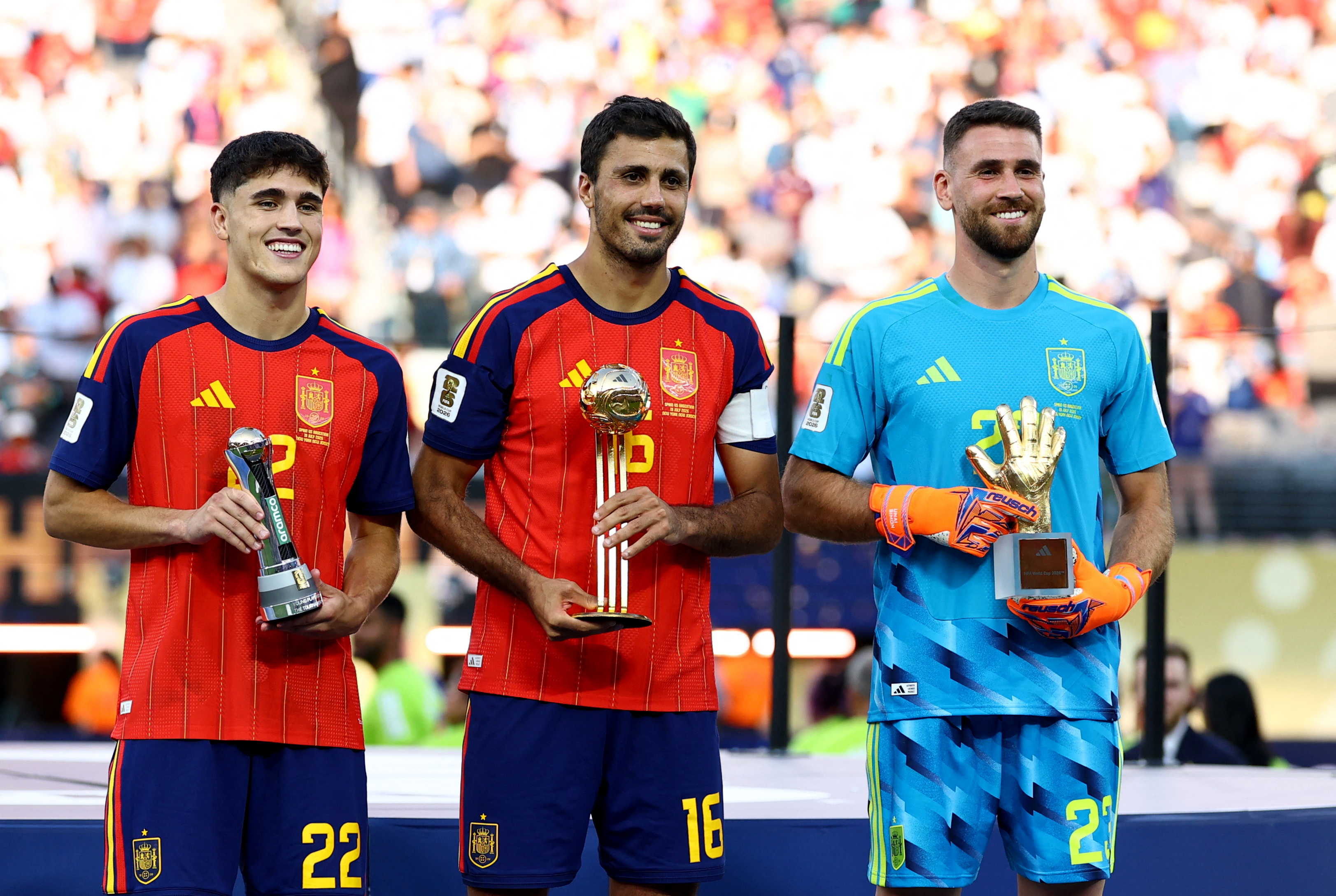 Soccer Football - FIFA World Cup 2026 - Final - Spain v Argentina - New York/New Jersey Stadium, East Rutherford, New Jersey, U.S. - July 19, 2026 Spain's Rodri celebrates on the podium after winning the Golden Ball with Golden Glove winner Unai Simon and