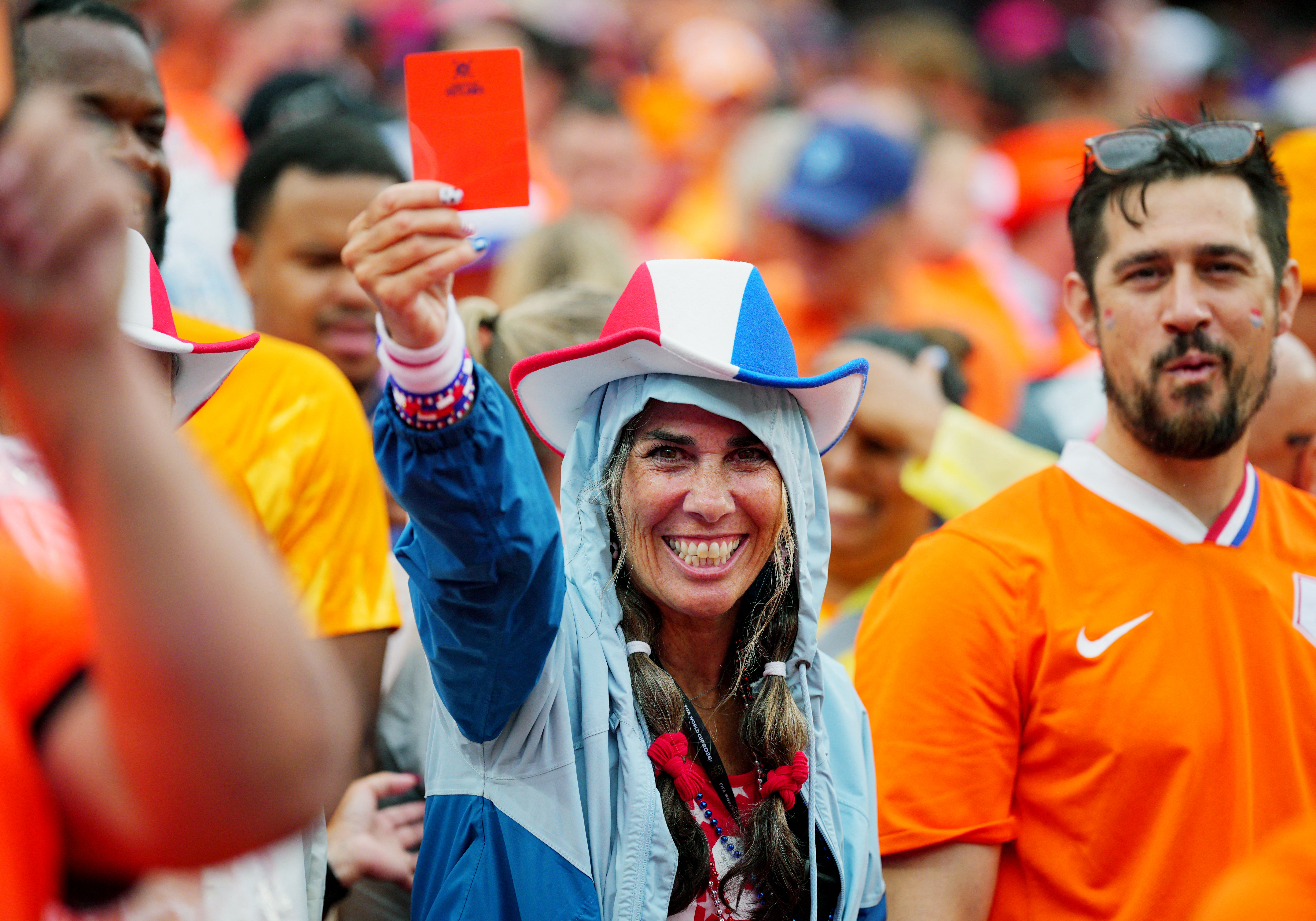 Soccer Football - FIFA World Cup 2026 - Group F - Tunisia v Netherlands - Kansas City Stadium, Kansas City, Missouri, U.S. - June 25, 2026 A Netherlands fan holds a red card inside the stadium before the match IMAGN IMAGES via Reuters/Jay Biggerstaff