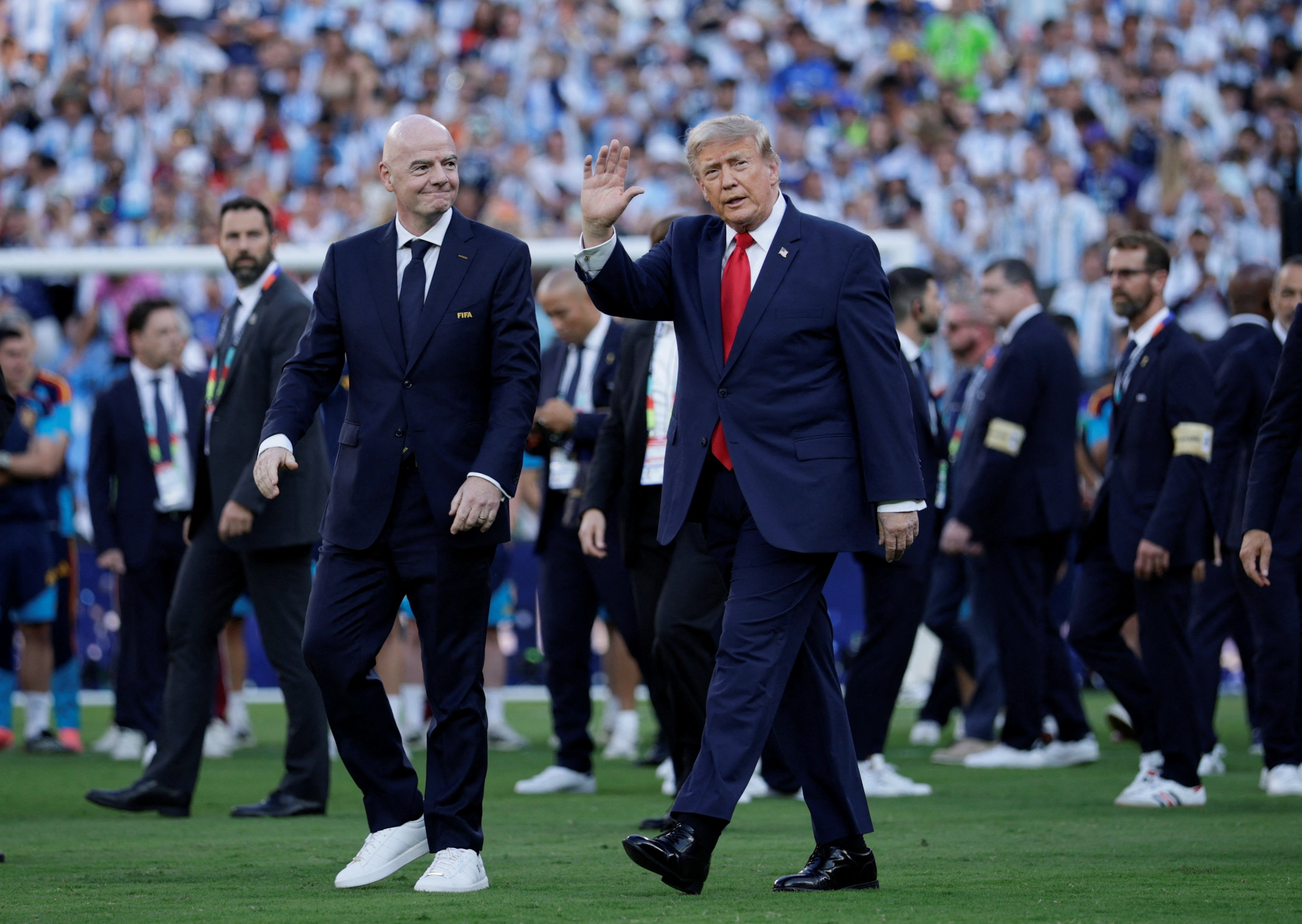 U.S. President Donald Trump and FIFA President Gianni Infantino walk to attend the