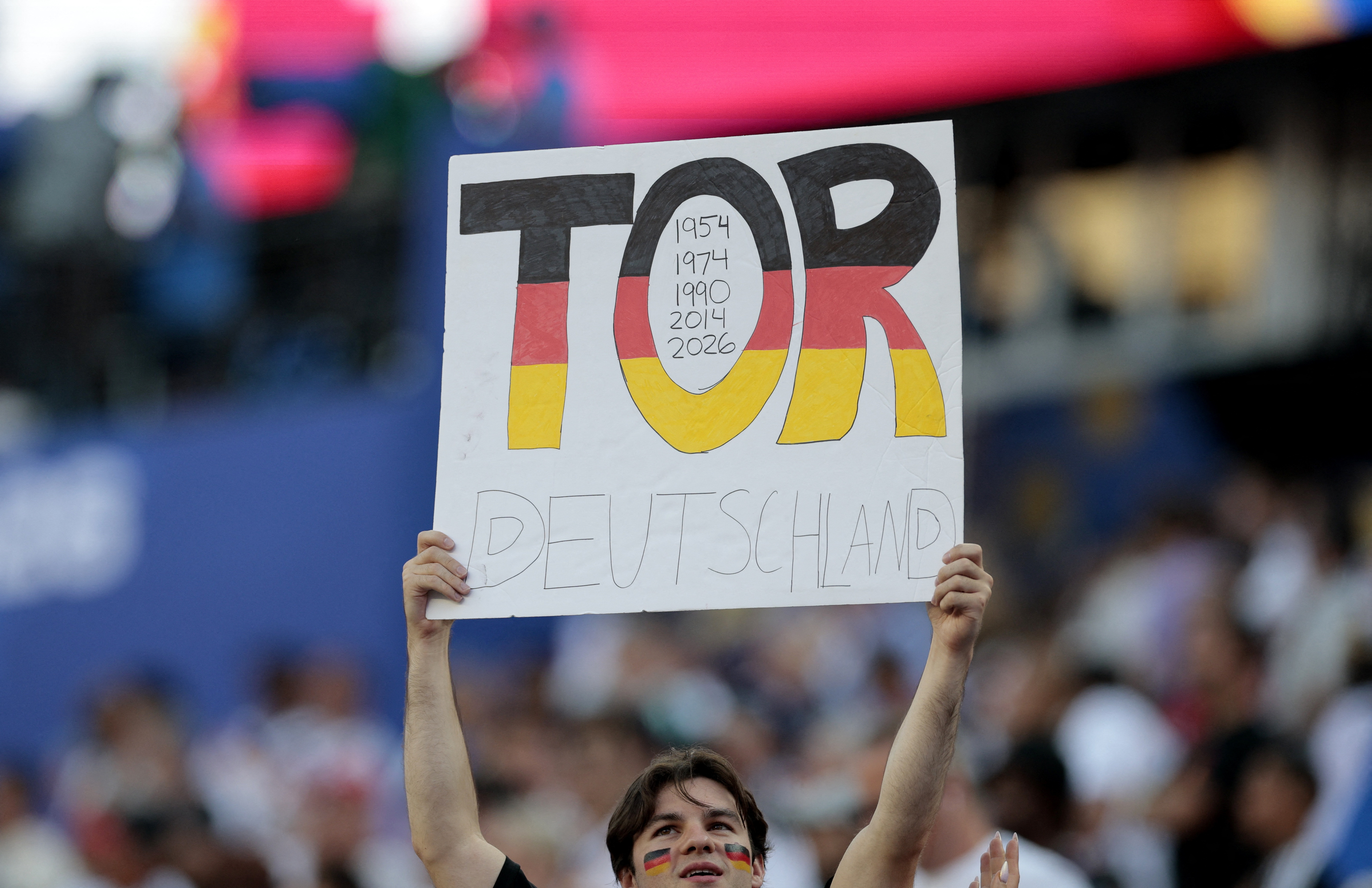Soccer Football - FIFA World Cup 2026 - Round of 32 - Germany v Paraguay - Boston Stadium, Foxborough, Massachusetts, U.S. - June 29, 2026 Germany fan holds up a poster inside the stadium during the match REUTERS/Brian Snyder