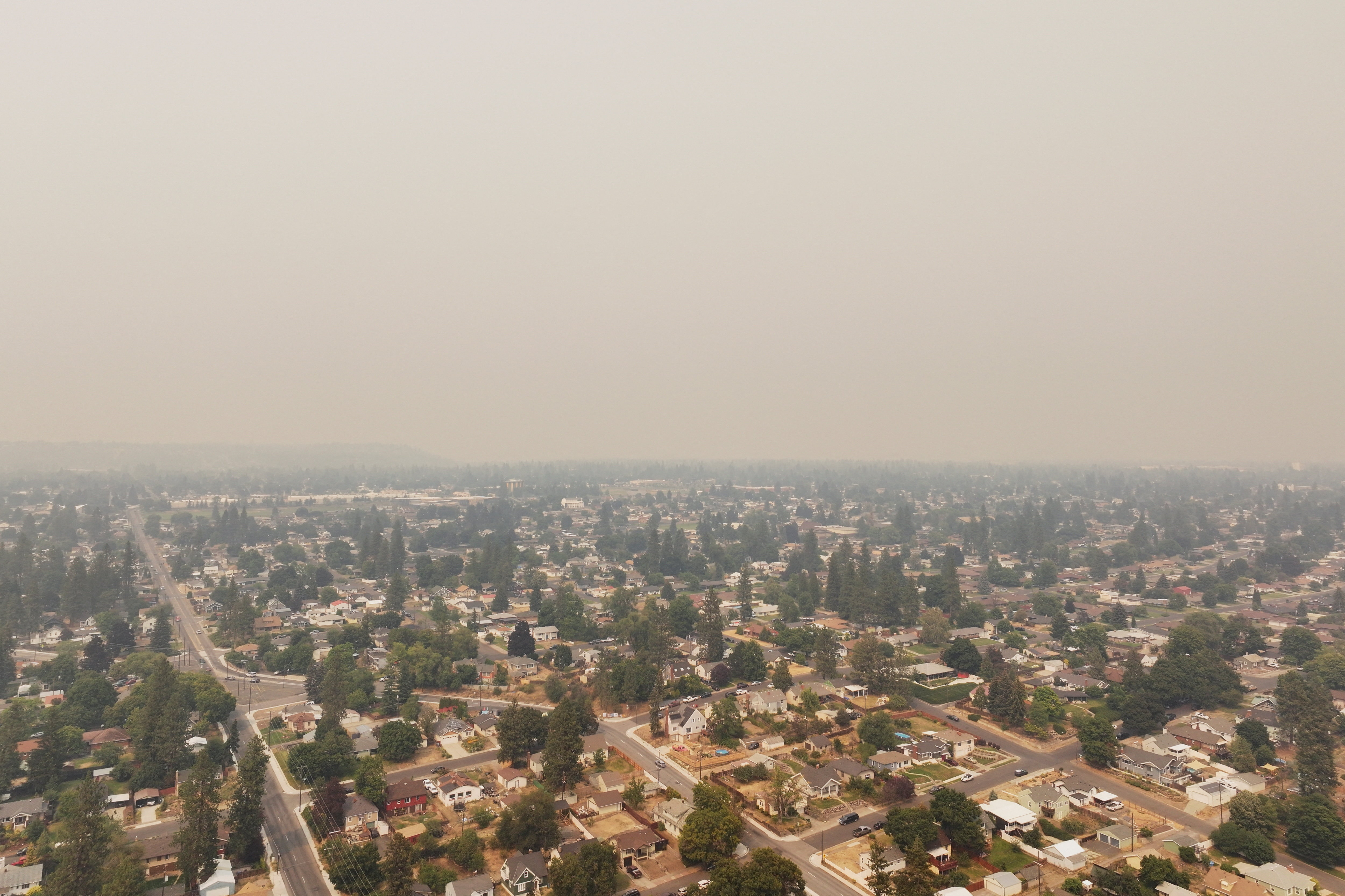 A drone view shows smoke enveloping the sky as a wildfire burns in the Spokane area, Washington, U.S., August 2, 2026. REUTERS/David Ryder