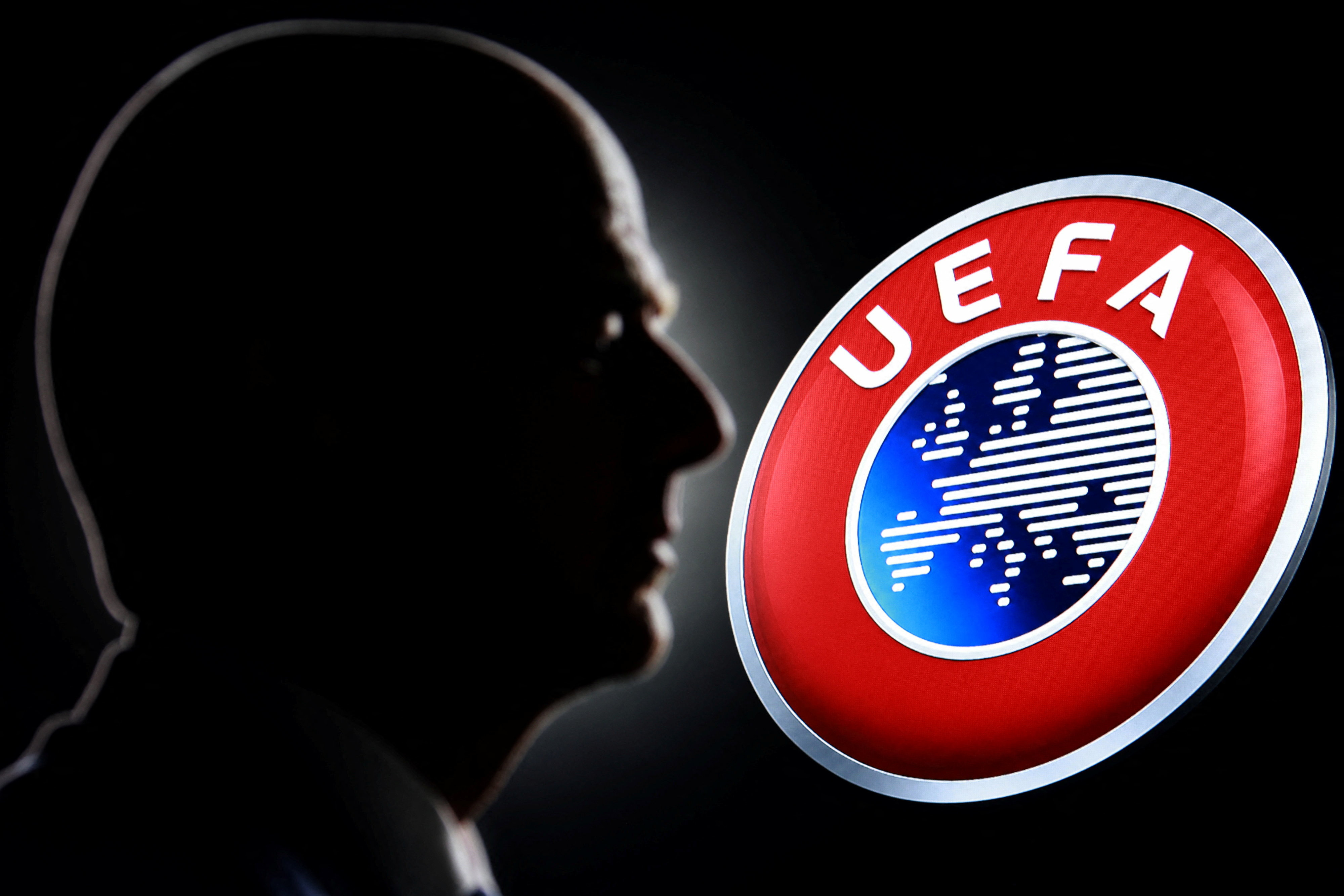 A silhouette depicting FIFA President Gianni Infantino is seen next to the UEFA logo in this illustration taken July 30, 2026. REUTERS/Dado Ruvic/Illustration