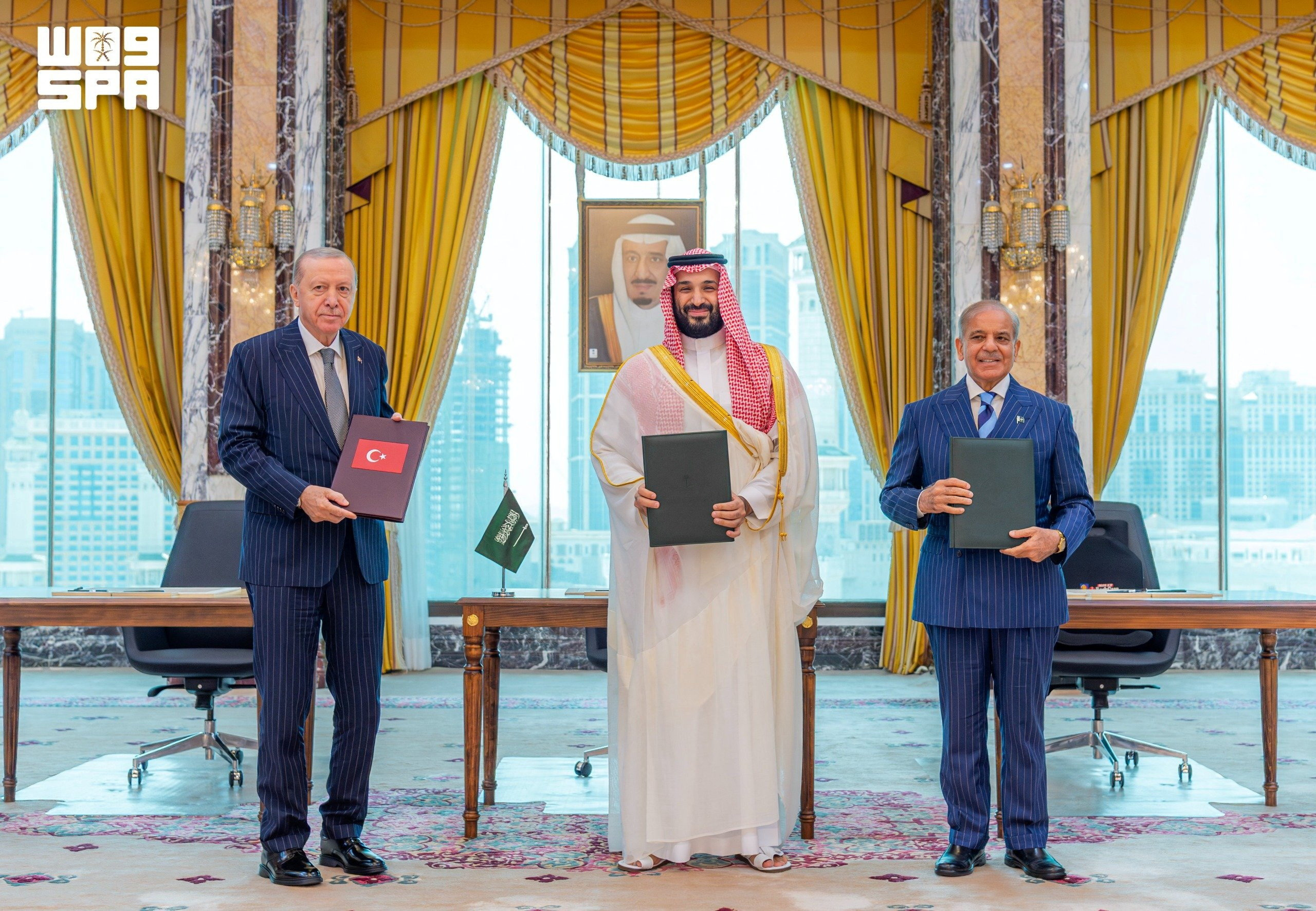 Turkish President Tayyip Erdogan, Saudi Crown Prince Mohammed bin Salman, and Pakistan's Prime Minister Shehbaz Sharif pose after signing a joint defence agreement in Mecca