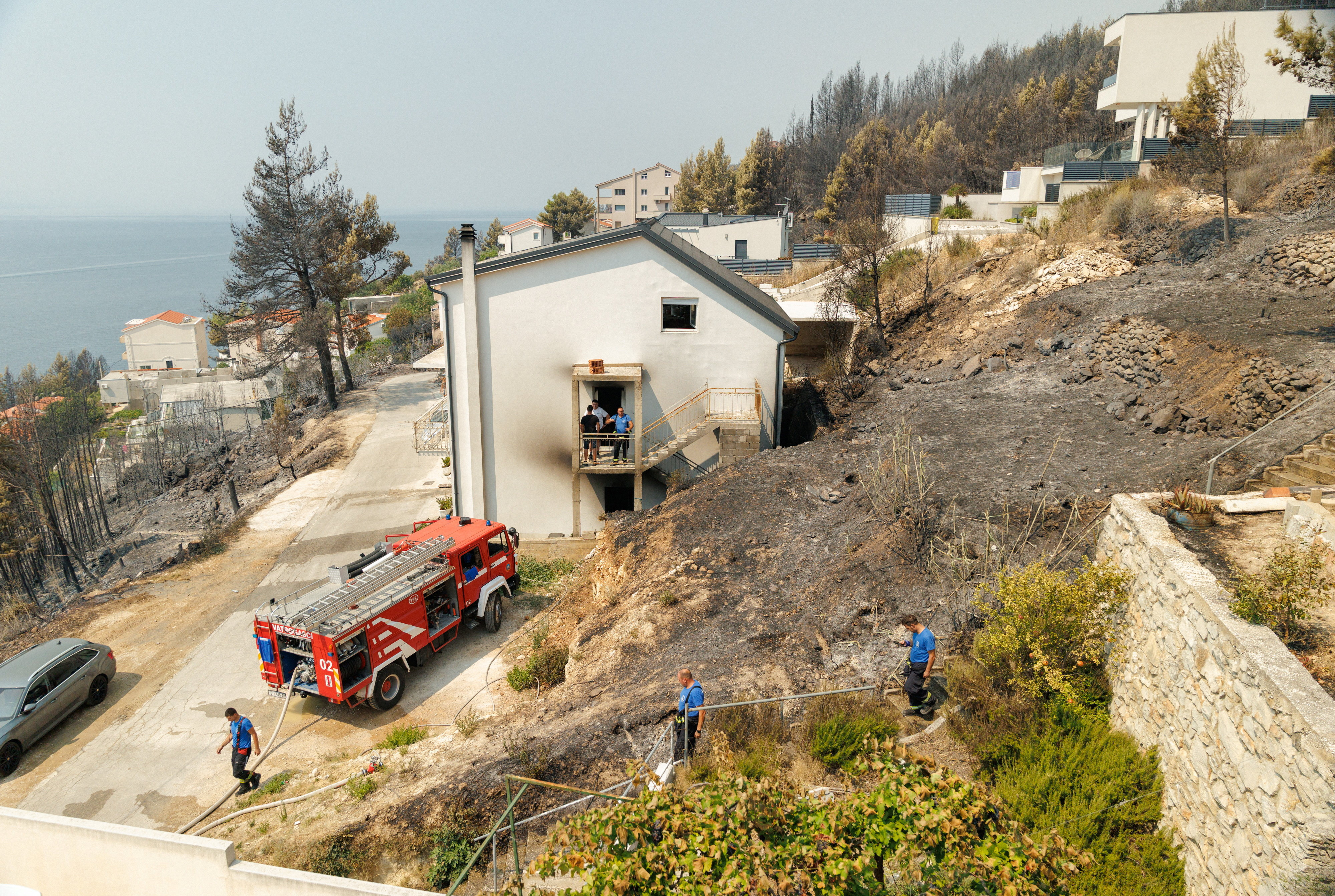 Firefighters work following wildfire in Stanici, Croatia, August 14, 2026. REUTERS/Antonio Bronic