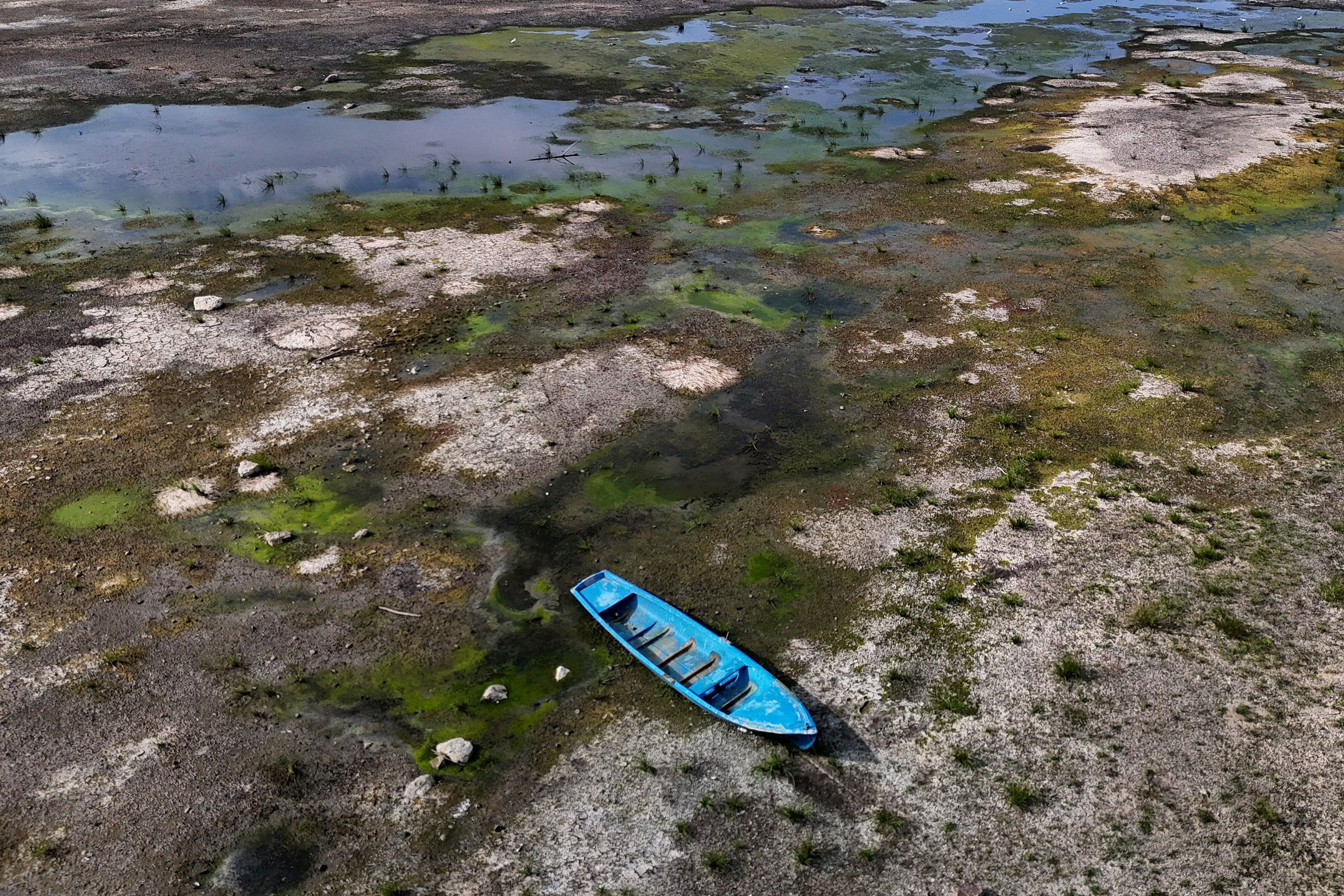 A drone view of a stranded boat on the exposed riverbed of the Danube River at record-low water levels, in Sandrovo, Bulgaria, August 13, 2026. REUTERS/Stoyan Nenov