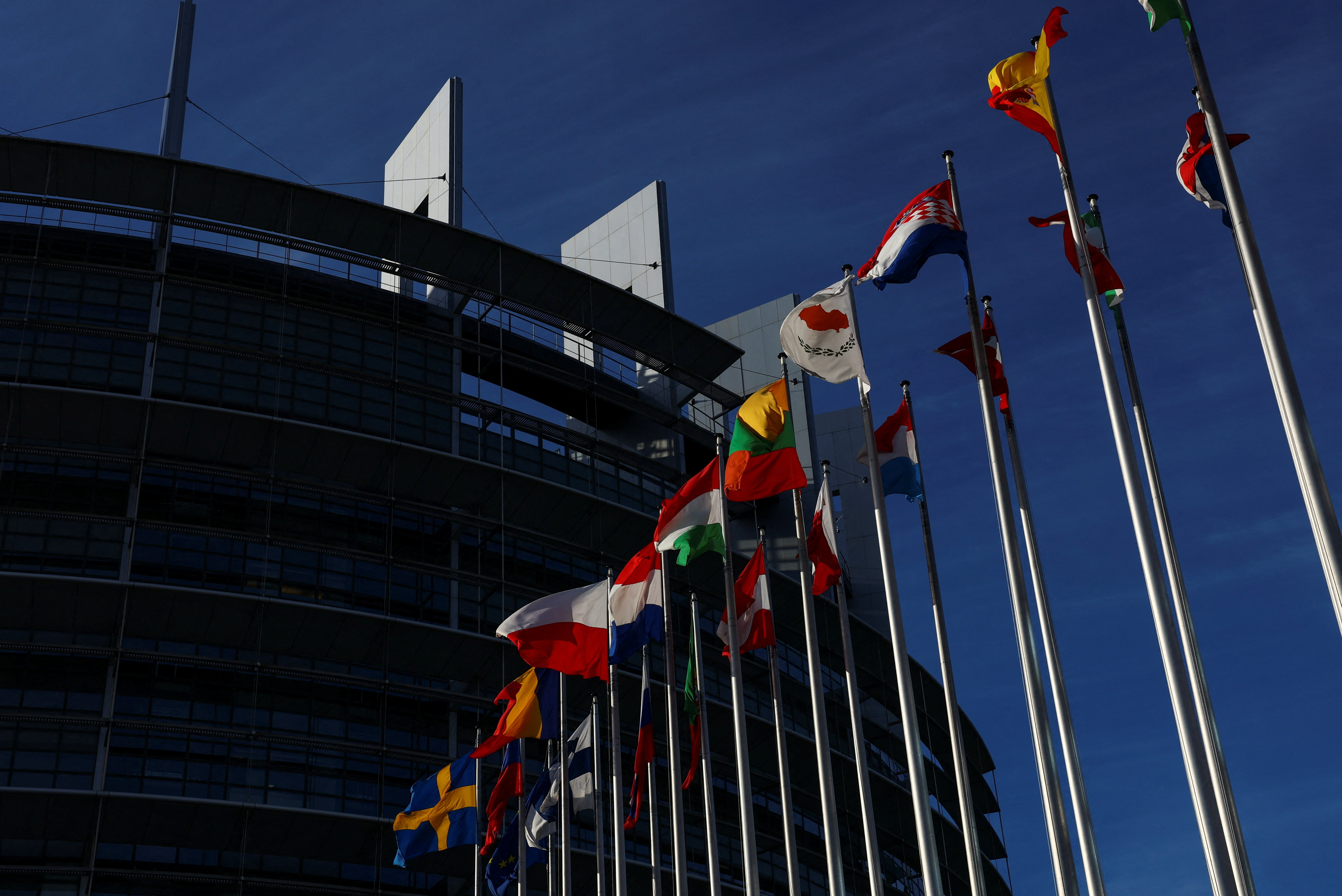 Flags flutter near the European Parliament building