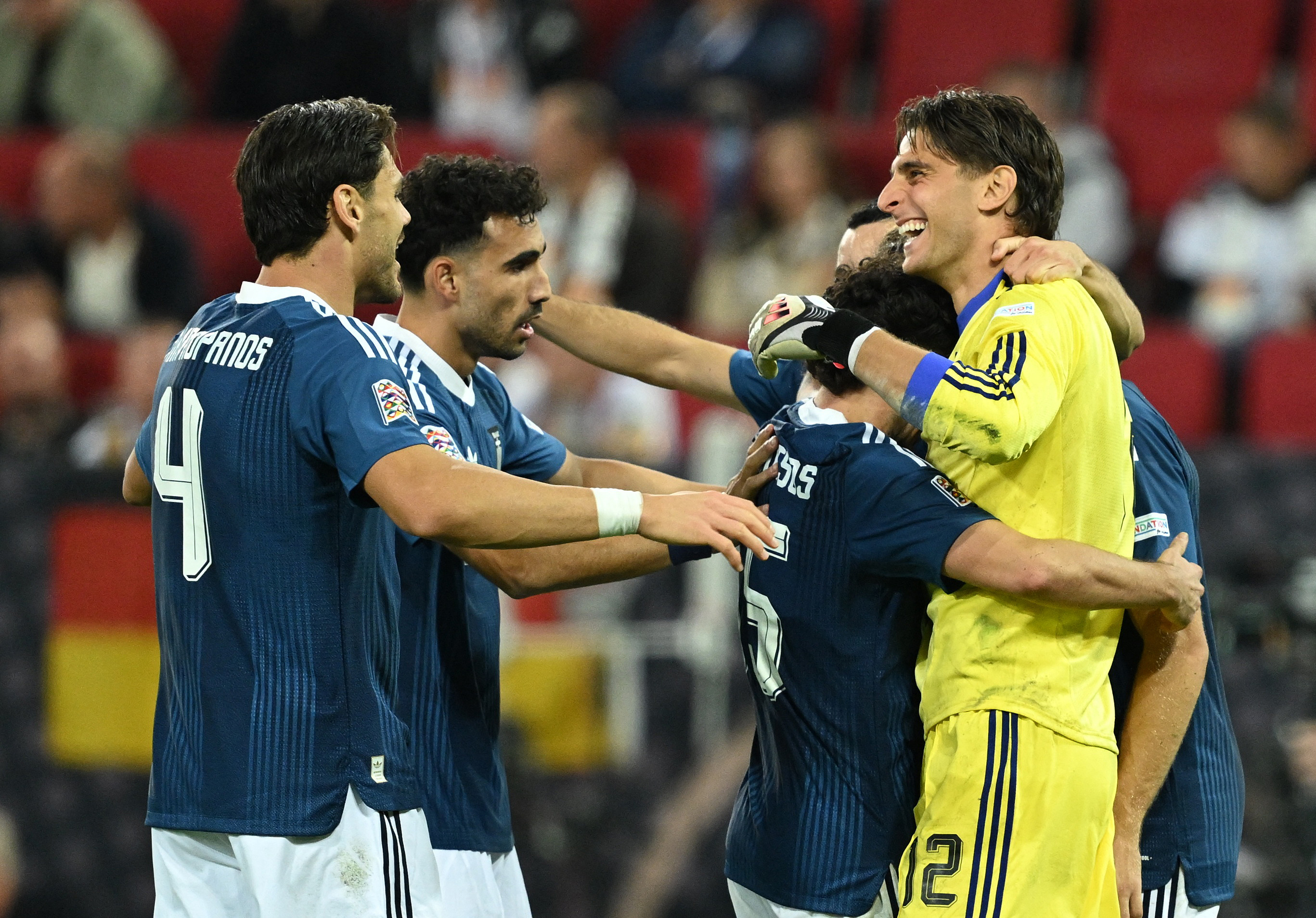 Soccer Football - Nations League - Group A2 - Germany v Greece - WWK Arena, Augsburg, Germany - September 27, 2026 Greece's Kostas Tzolakis and Ntinos Mavropanos celebrate after the match with teammates REUTERS/Angelika Warmuth