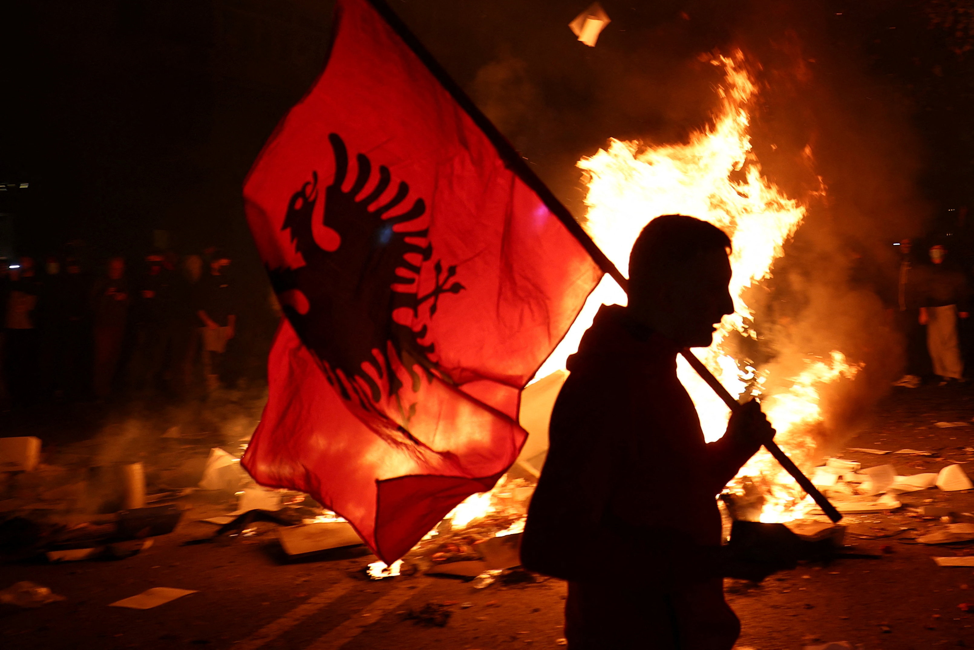A protester holds an Albanian national flag as Albanian students hold an anti-government protest in Tirana, Albania, October 13, 2026. REUTERS/Florion Goga