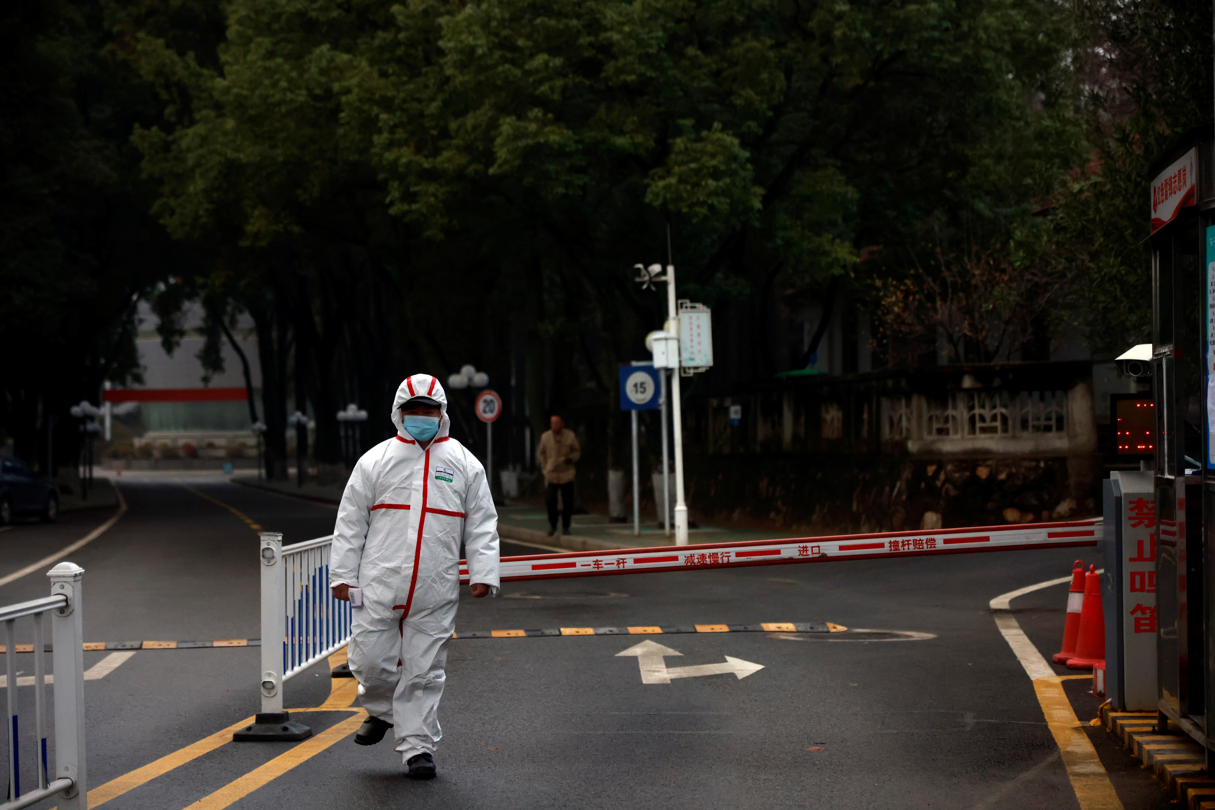 Security personnel looks on during the visit by members of the WHO team tasked with investigating the origins of the coronavirus disease (COVID-19), at the Hubei provincial center for disease control in Wuhan