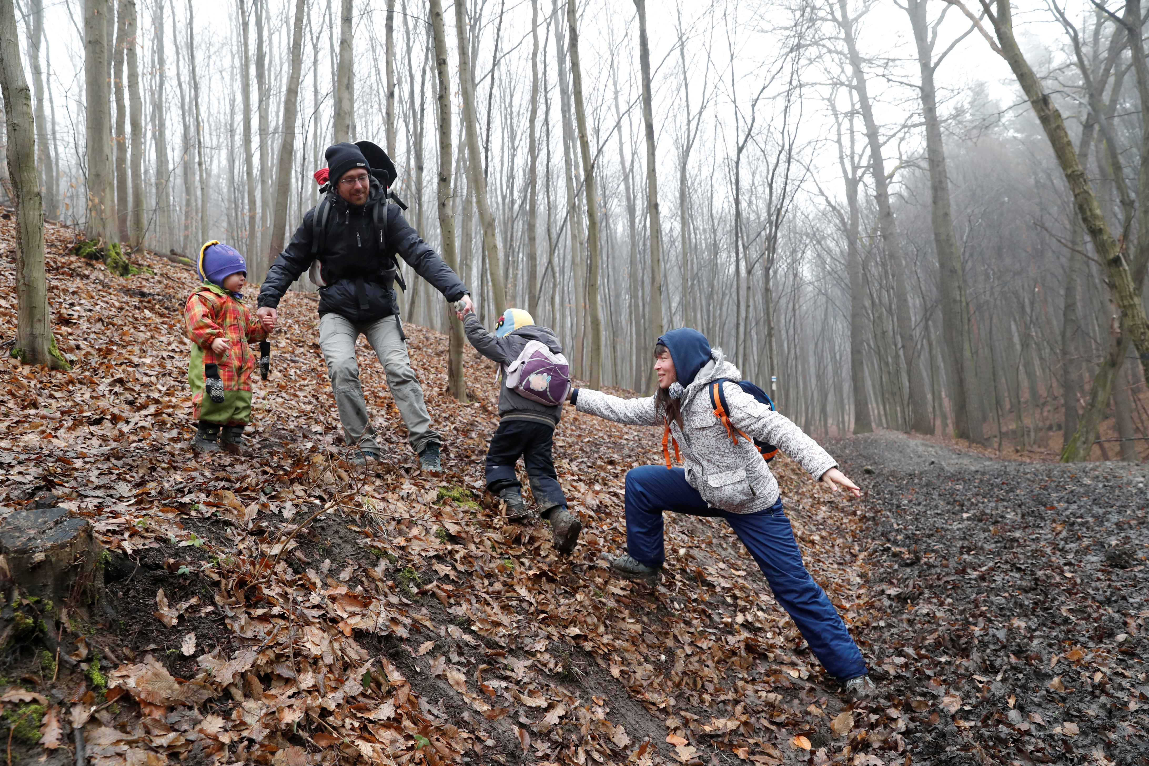 Miklosi and his wife Kovacs help their son Vilmos, 4, as they hike on National Blue Trail along the Pilis Mountains near Pilisszentlaszlo