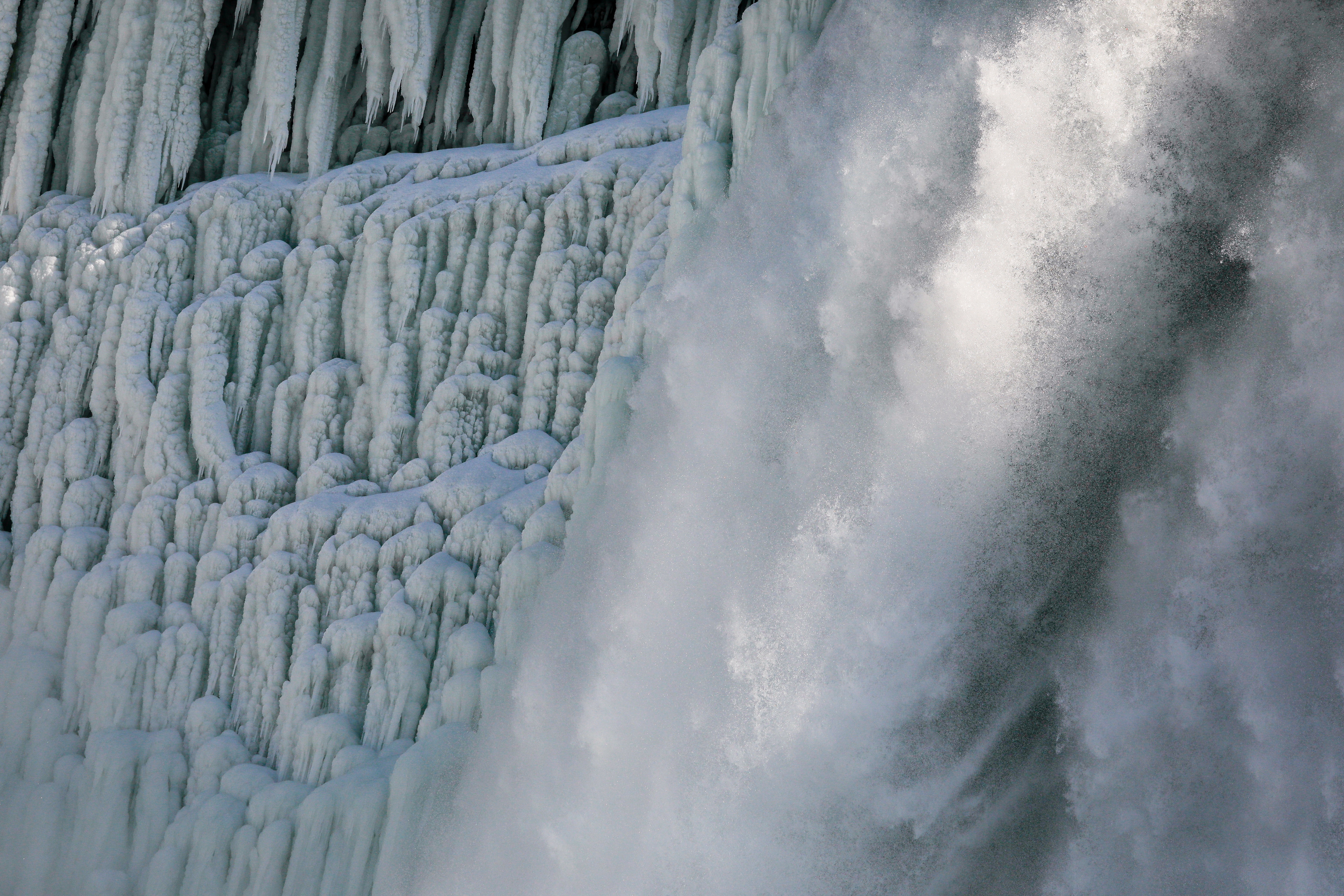 Water flowing around ice sits at the American Falls due to cold temperatures in Niagara Falls, New York