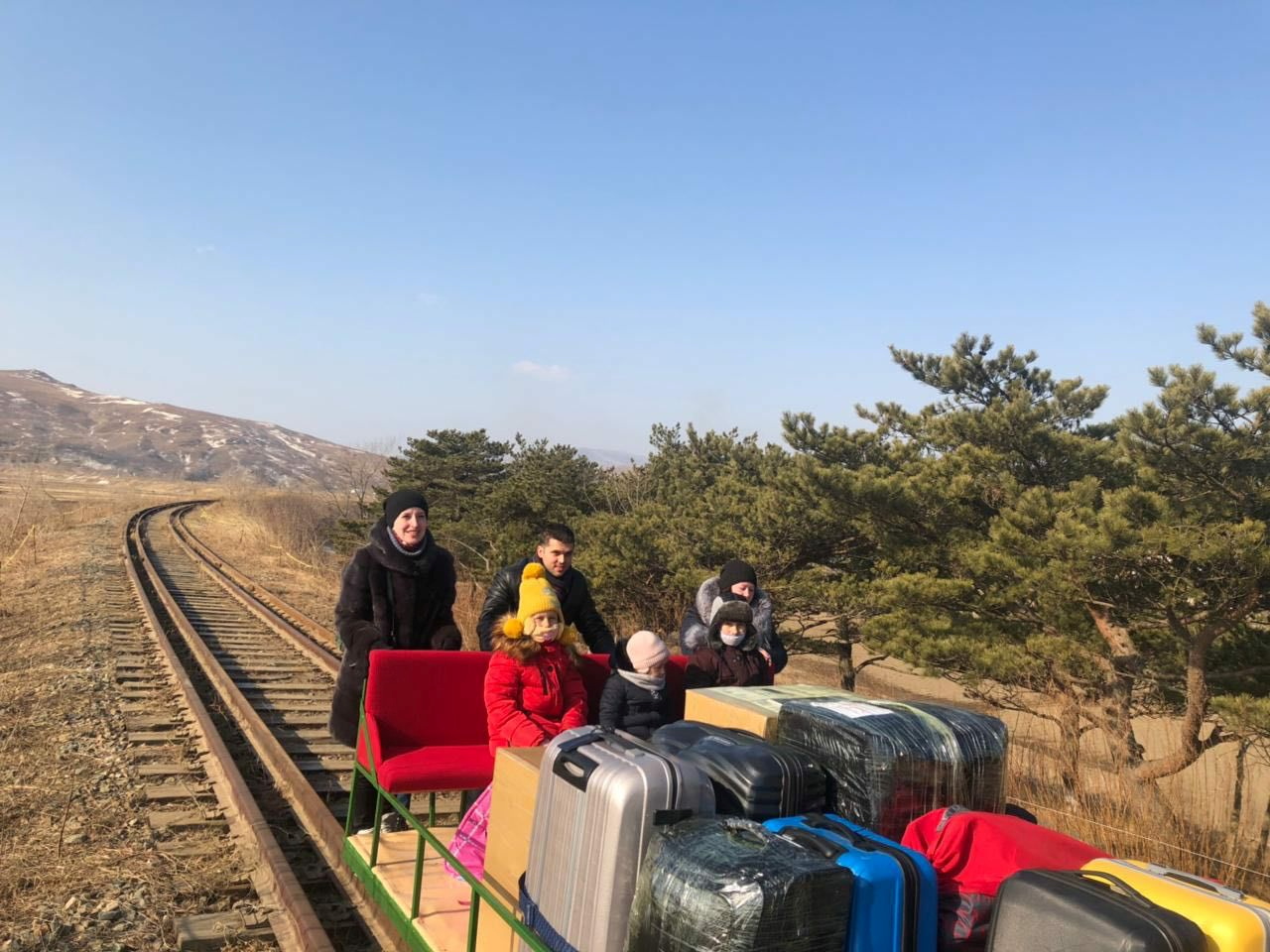 Russian diplomats use a hand-pushed rail trolley while crossing the demarcation line between North Korea and Russia