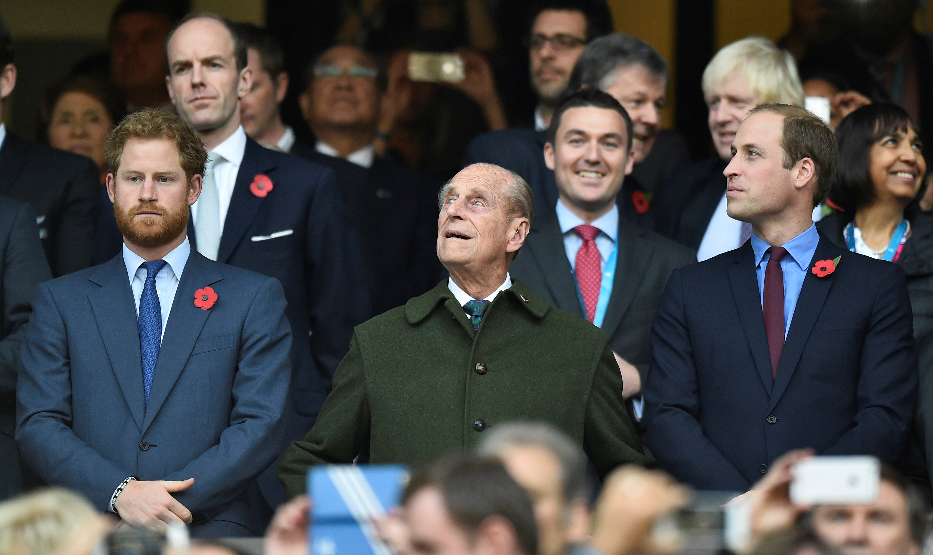 FILE PHOTO: Britain's Prince Harry, Prince Philip and Prince William attend the Rugby World Cup final match between New Zealand against Australia at Twickenham in London