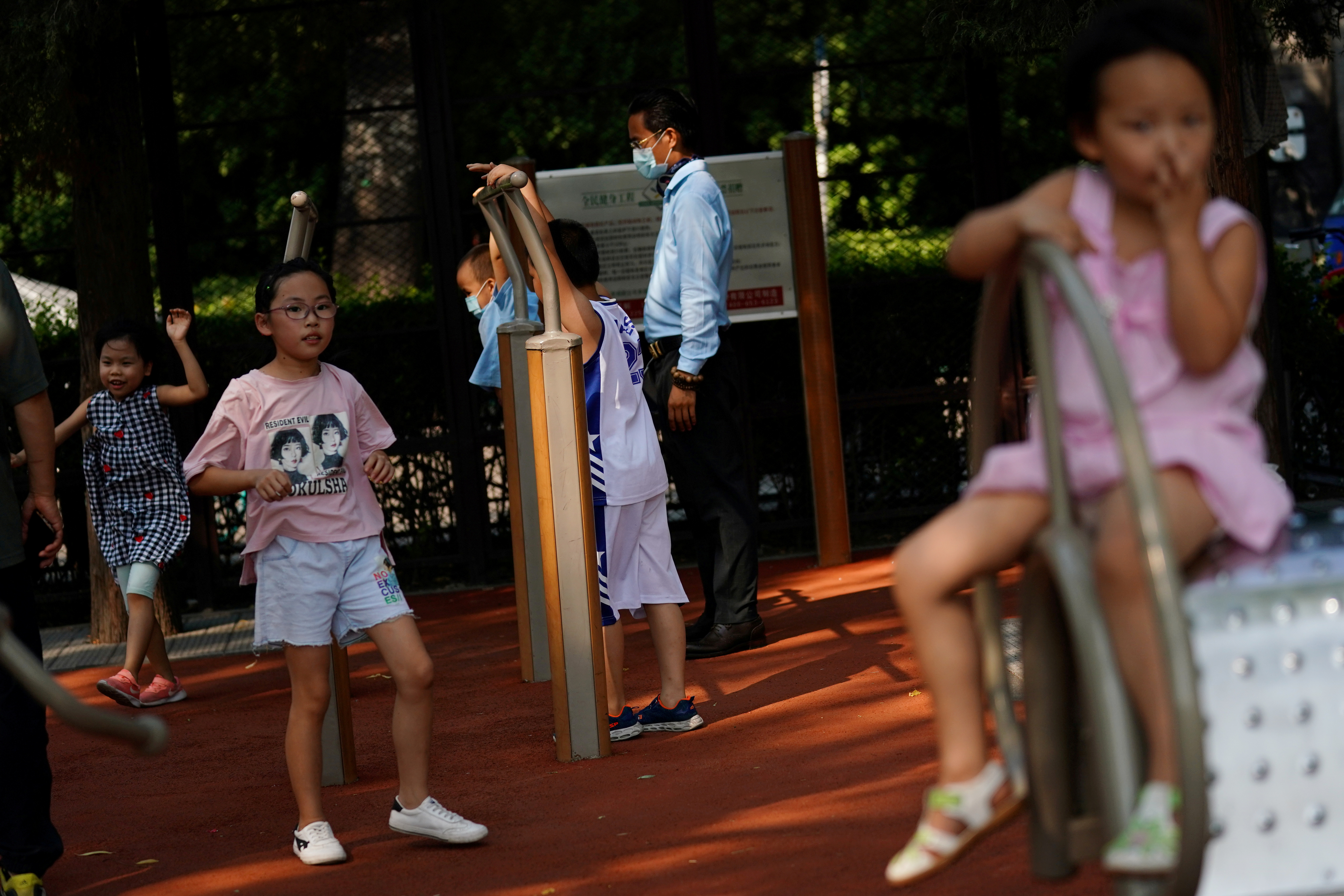 FILE PHOTO: Children play at an exercise area near Houhai Lake, following the coronavirus disease (COVID-19) outbreak, in Beijing