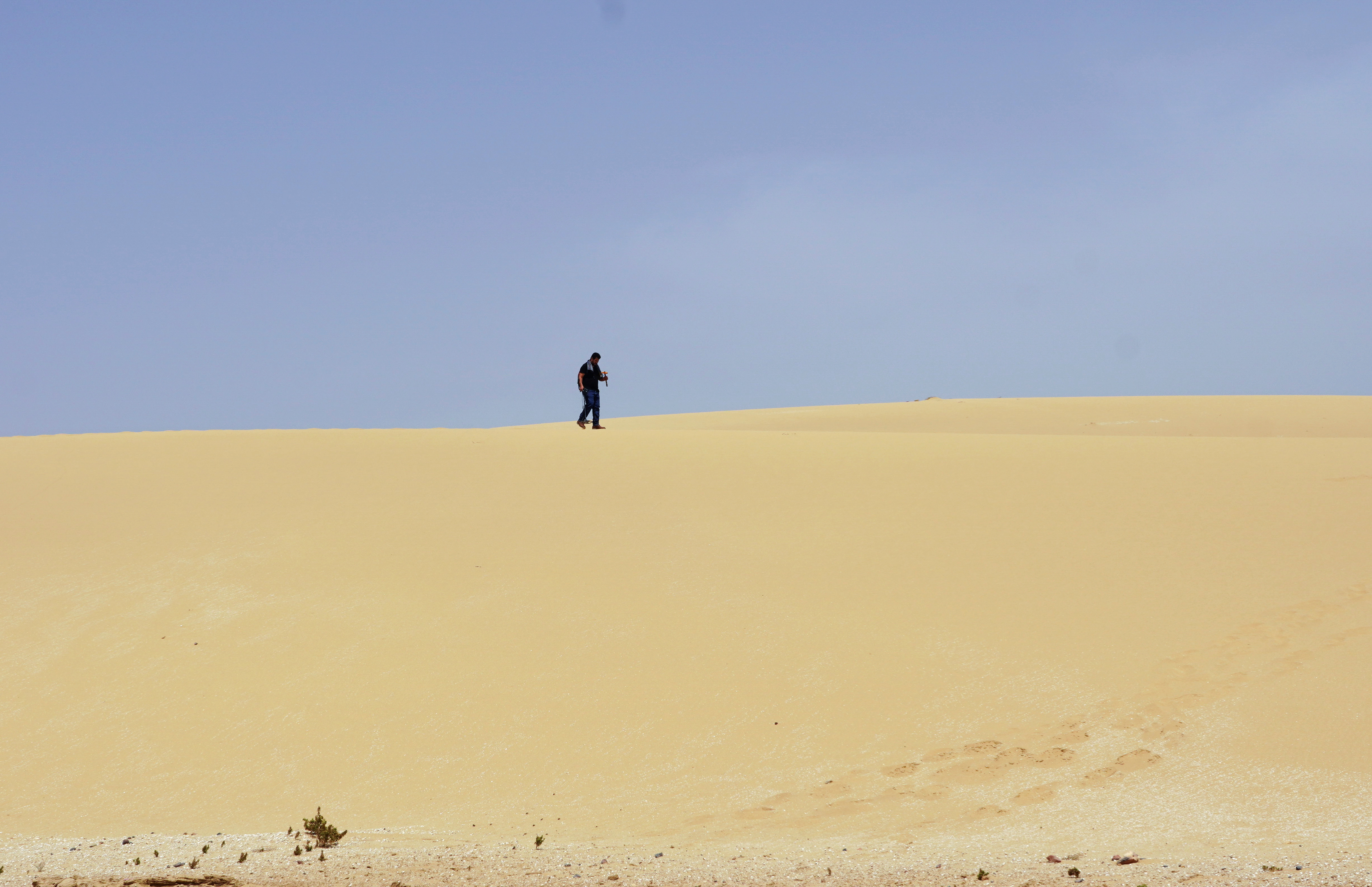 Meteorite hunter, Ali Lamghari, searches for meteorites in the sand dunes near Tamri village