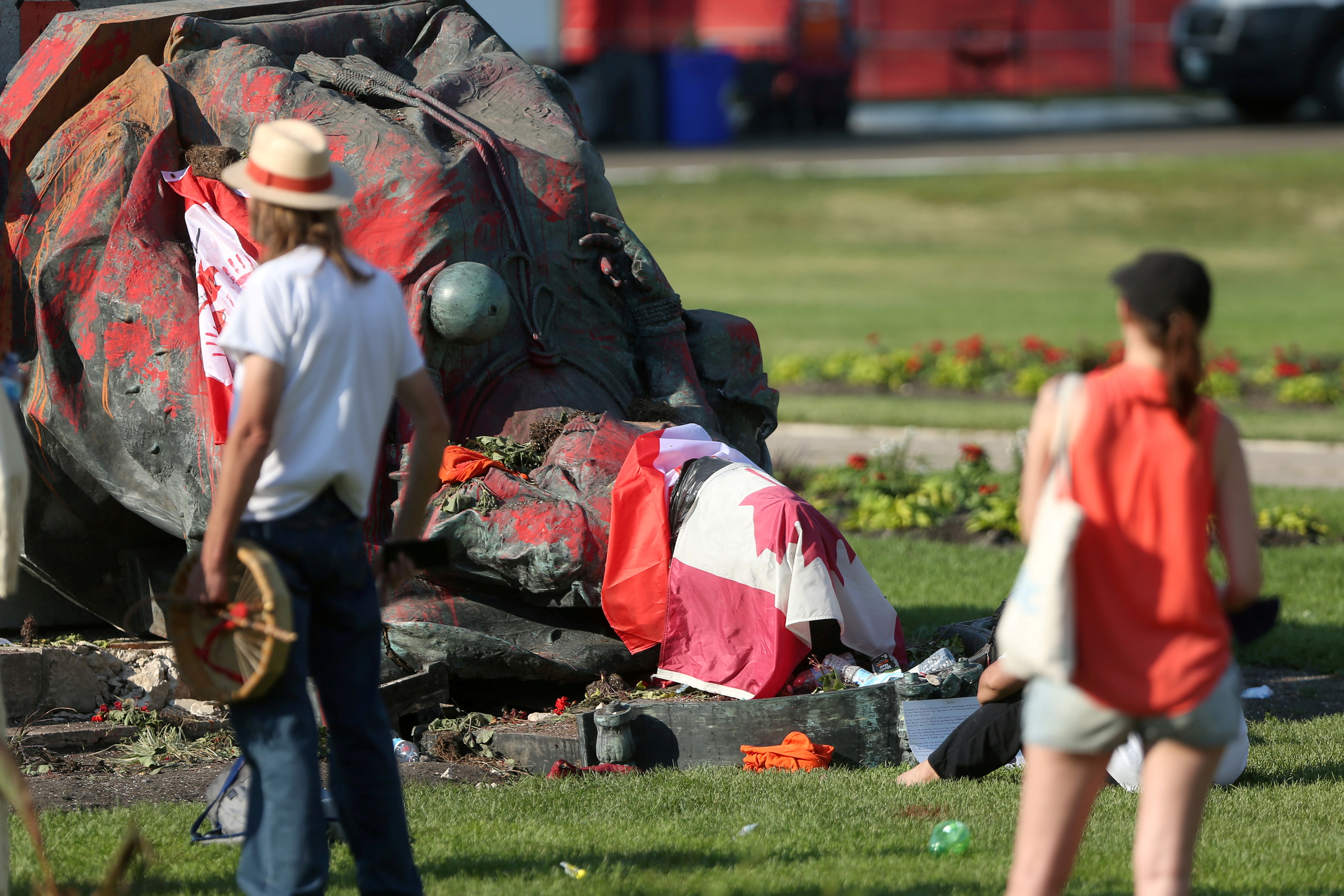 A defaced statue of Queen Victoria lies after being toppled during a rally on Canada Day in Winnipeg