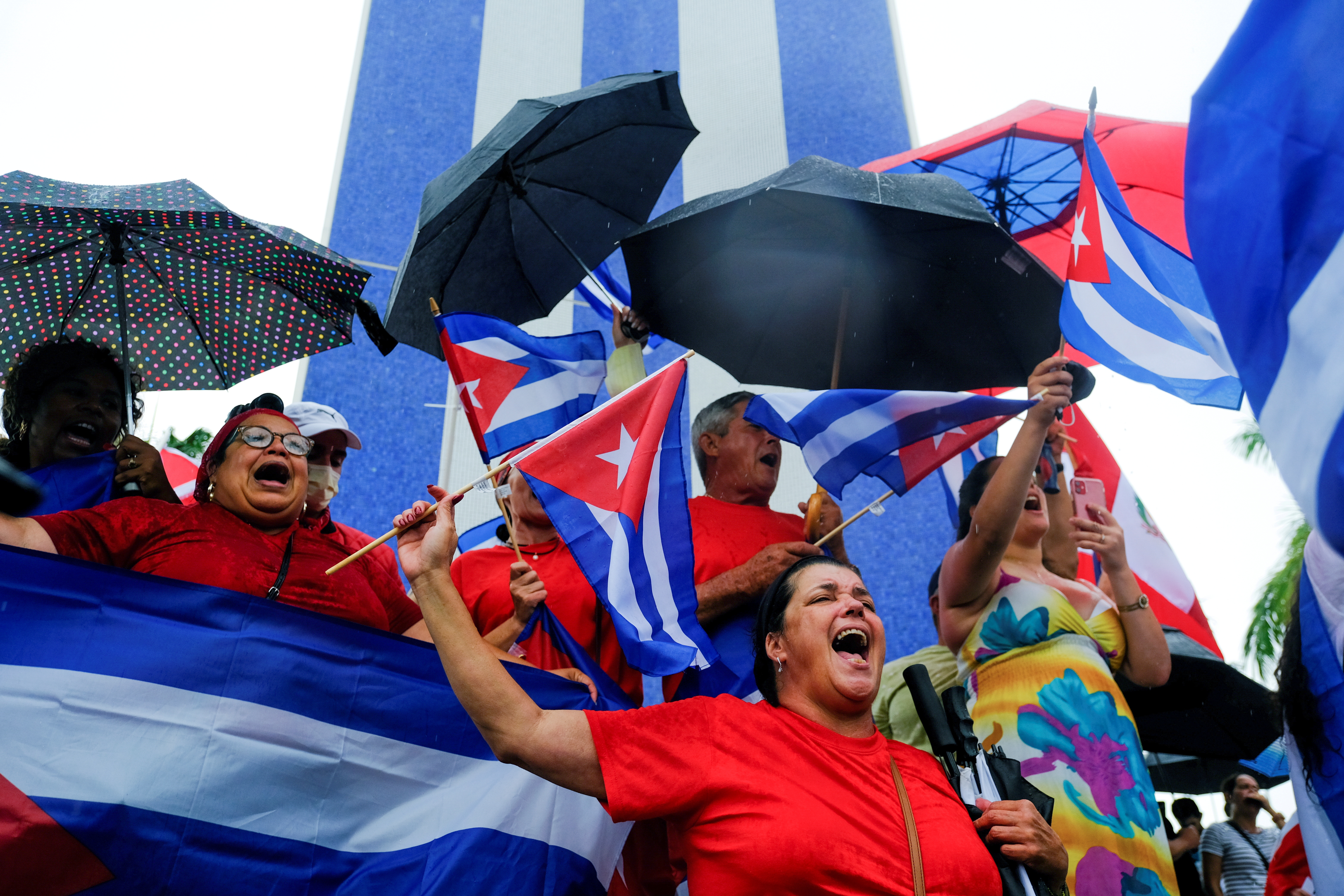 Emigres in the Little Havana neighborhood react to reports of protests in Cuba against its deteriorating economy, in Miami