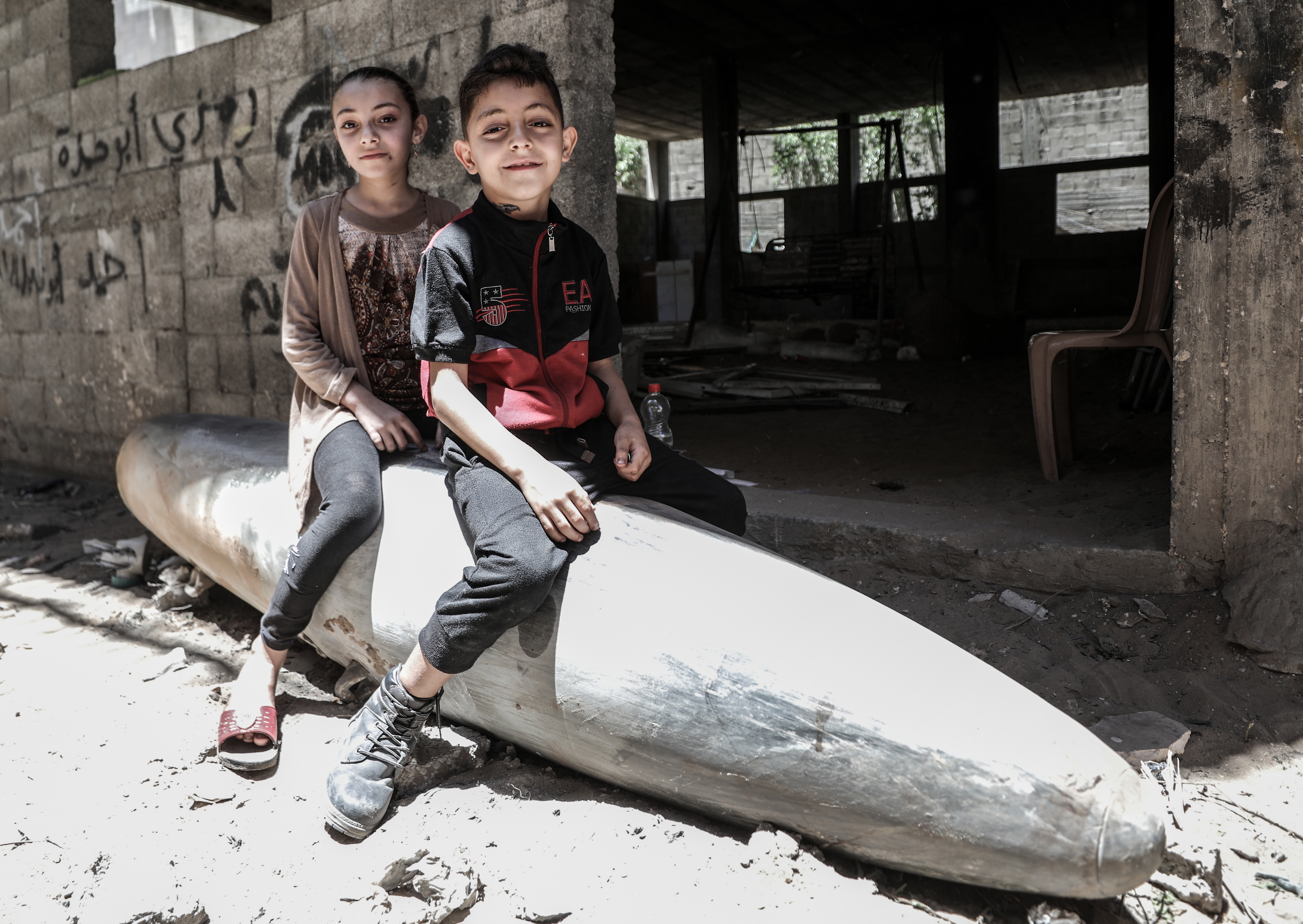 Izraelski napadi na Gazu: Palestinski mališani igraju se neeksplodiranim projektilom