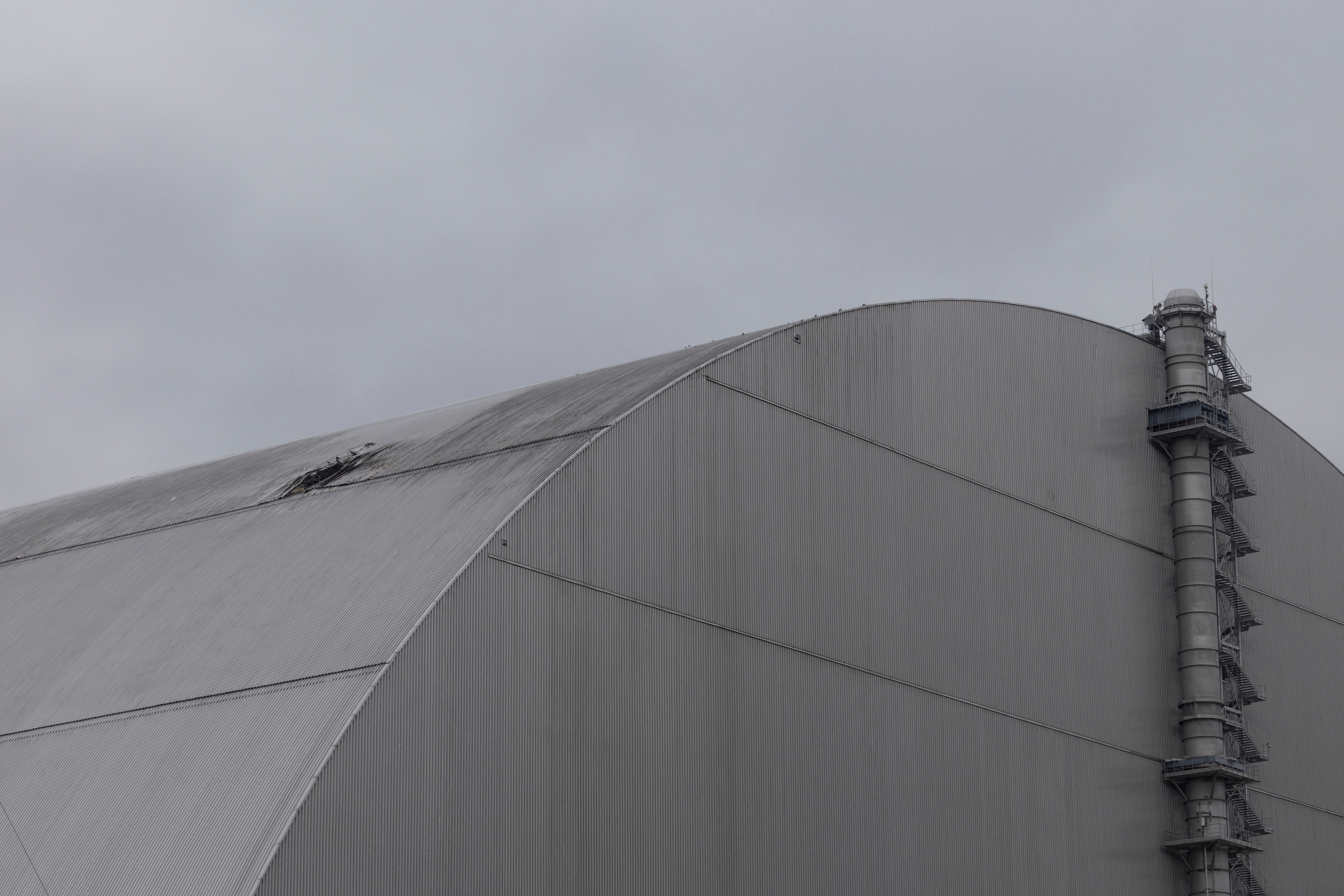 A view shows the New Safe Confinement (NSC) structure, that covers the old sarcophagus which confines the remains of the damaged fourth reactor, and was damaged by a drone strike amid ongoing Russia's attack on Ukraine, at the Chornobyl Nuclear Power Plan