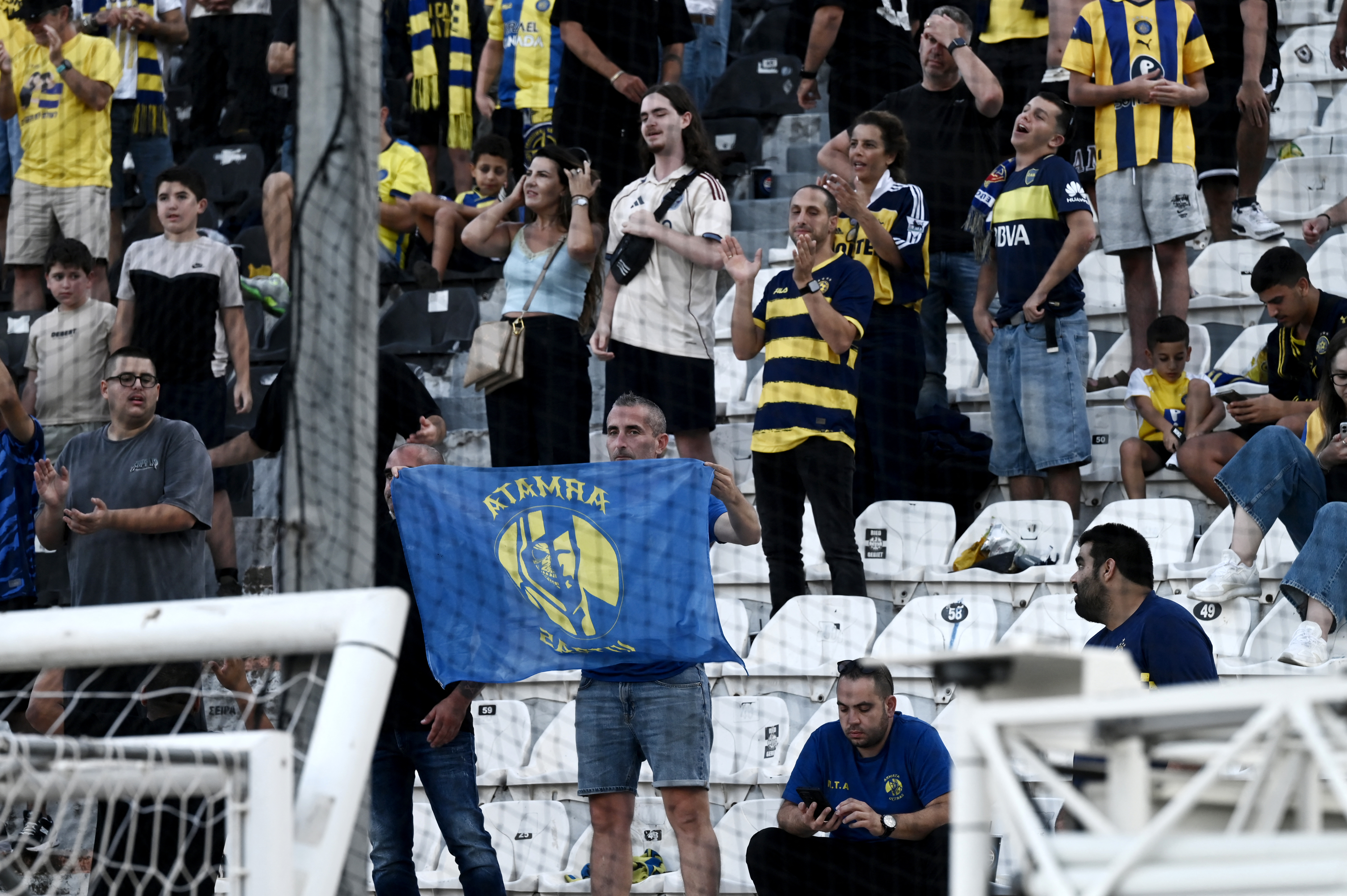 Maccabi's supporters gather in the stands before the UEFA Europa League football match day 1, between PAOK Salonika and Maccabi Tel-Aviv at the Toumba Stadium, in Thessaloniki on September 24, 2025. (Photo by SAKIS MITROLIDIS / AFP)