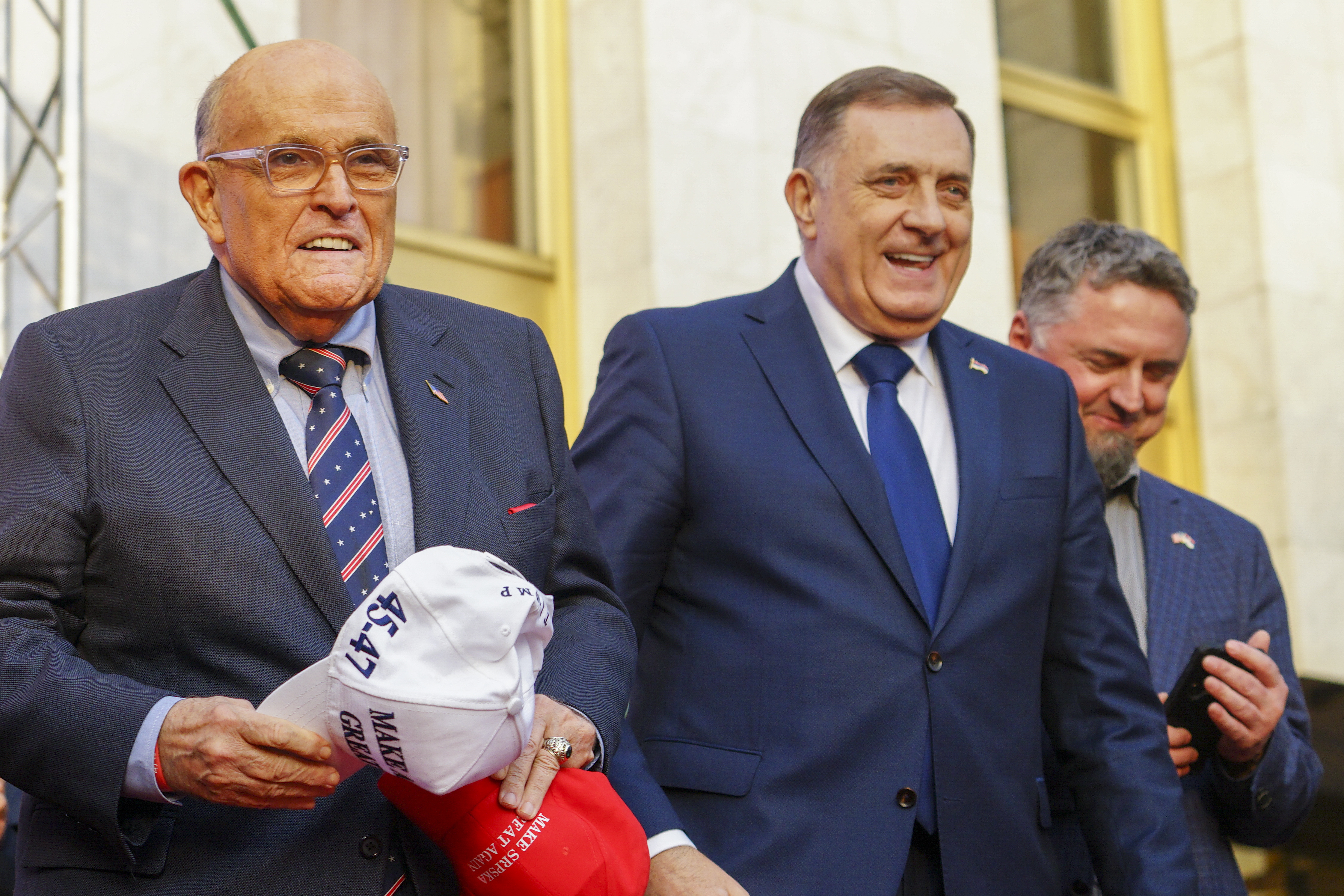 Bosnian Serb President Milorad Dodik, center, and former New York City mayor Rudy Giuliani, left in the Bosnian town of Banja Luka Tuesday, Feb. 25, 2025. (AP Photo/Radivoje Pavicic)