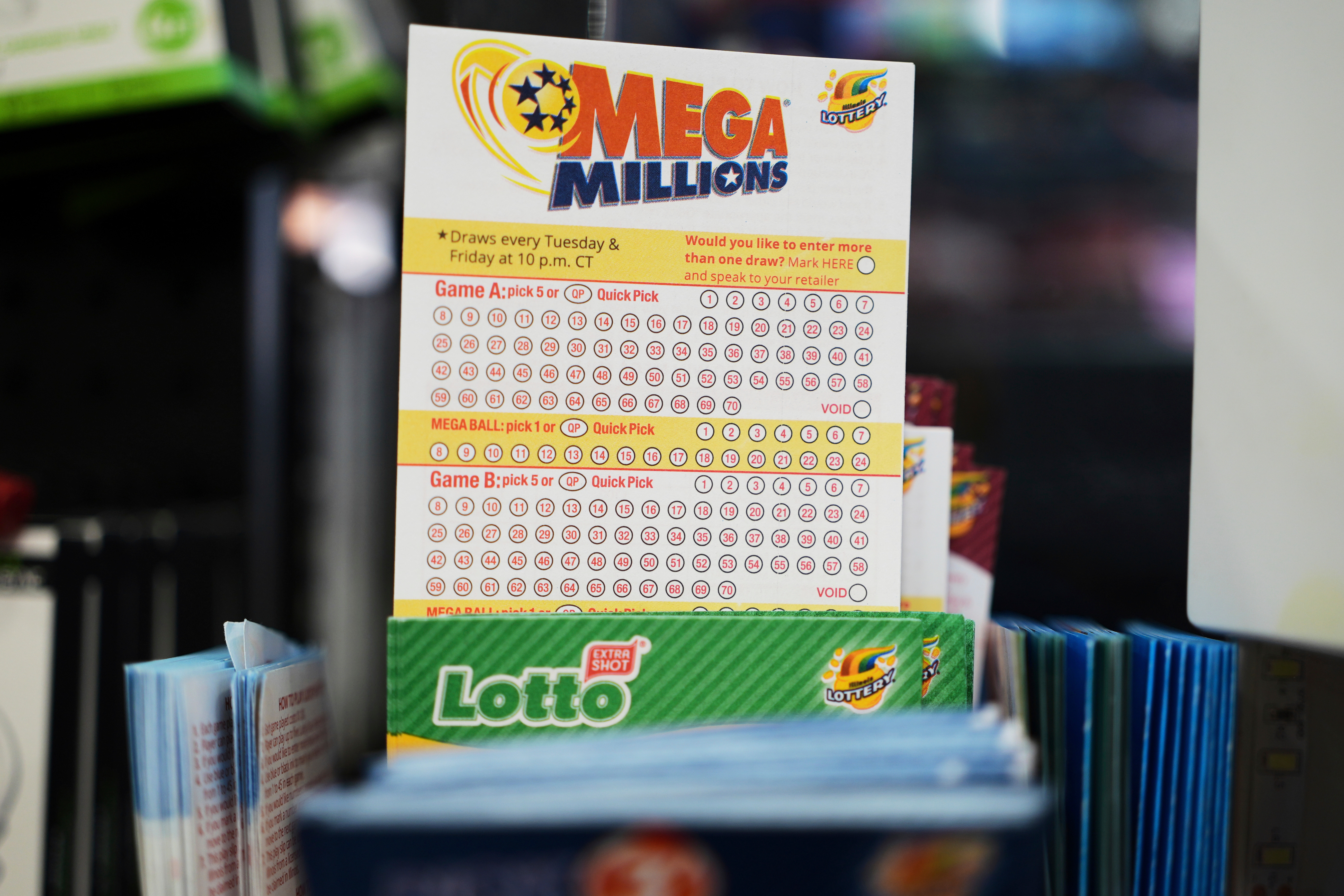FILE - Mega Millions Lottery play slips are displayed for