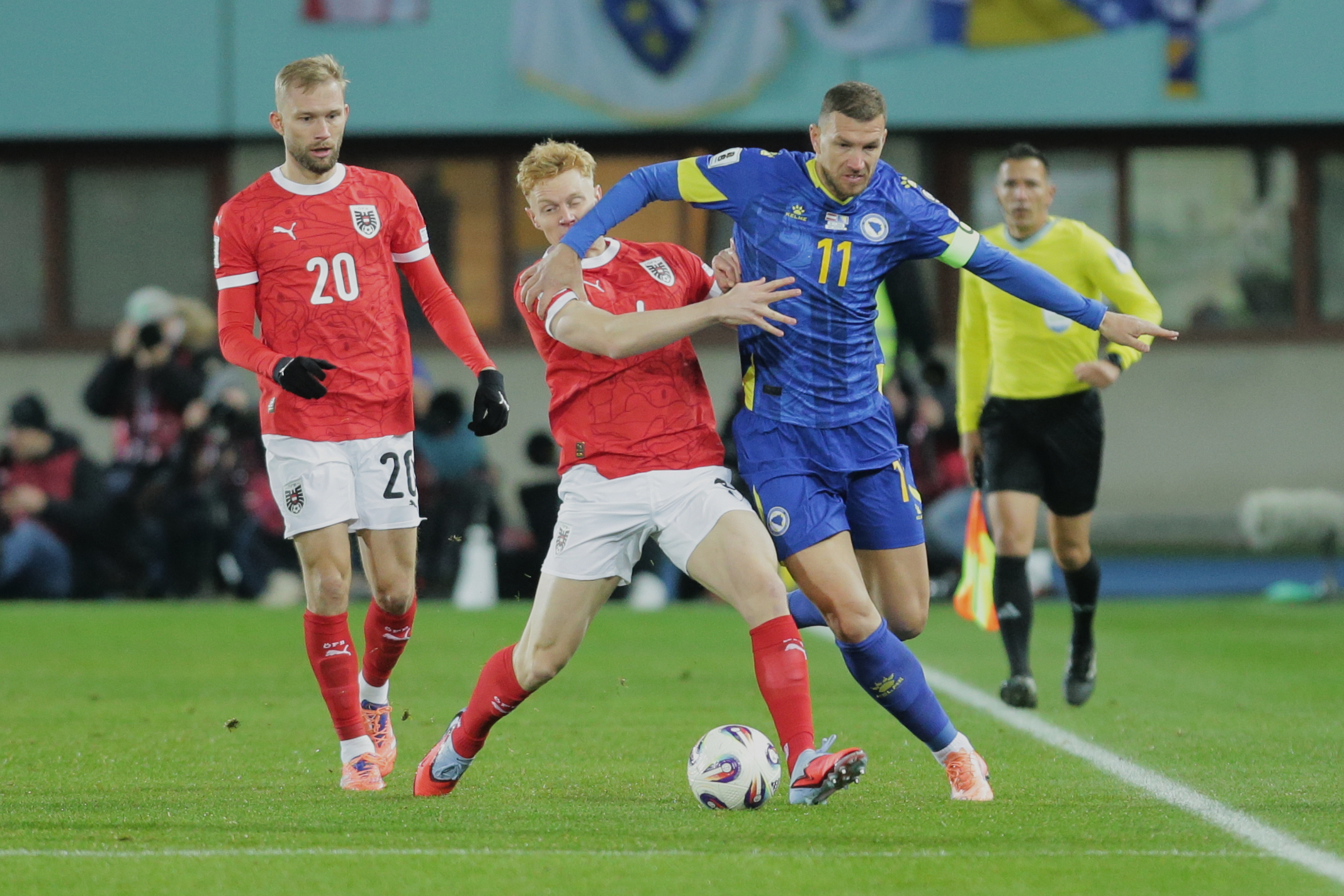 Austria's Nicolas Seiwald, left, and Bosnia and Herzegovina's Edin Dezeko challenge for the ball a group H World Cup qualifiying soccer match between Austria and Bosnia and Herzegovina in Vienna, Austria, Tuesday, Nov. 18, 2025. (AP Photo/Heinz-Peter Bade