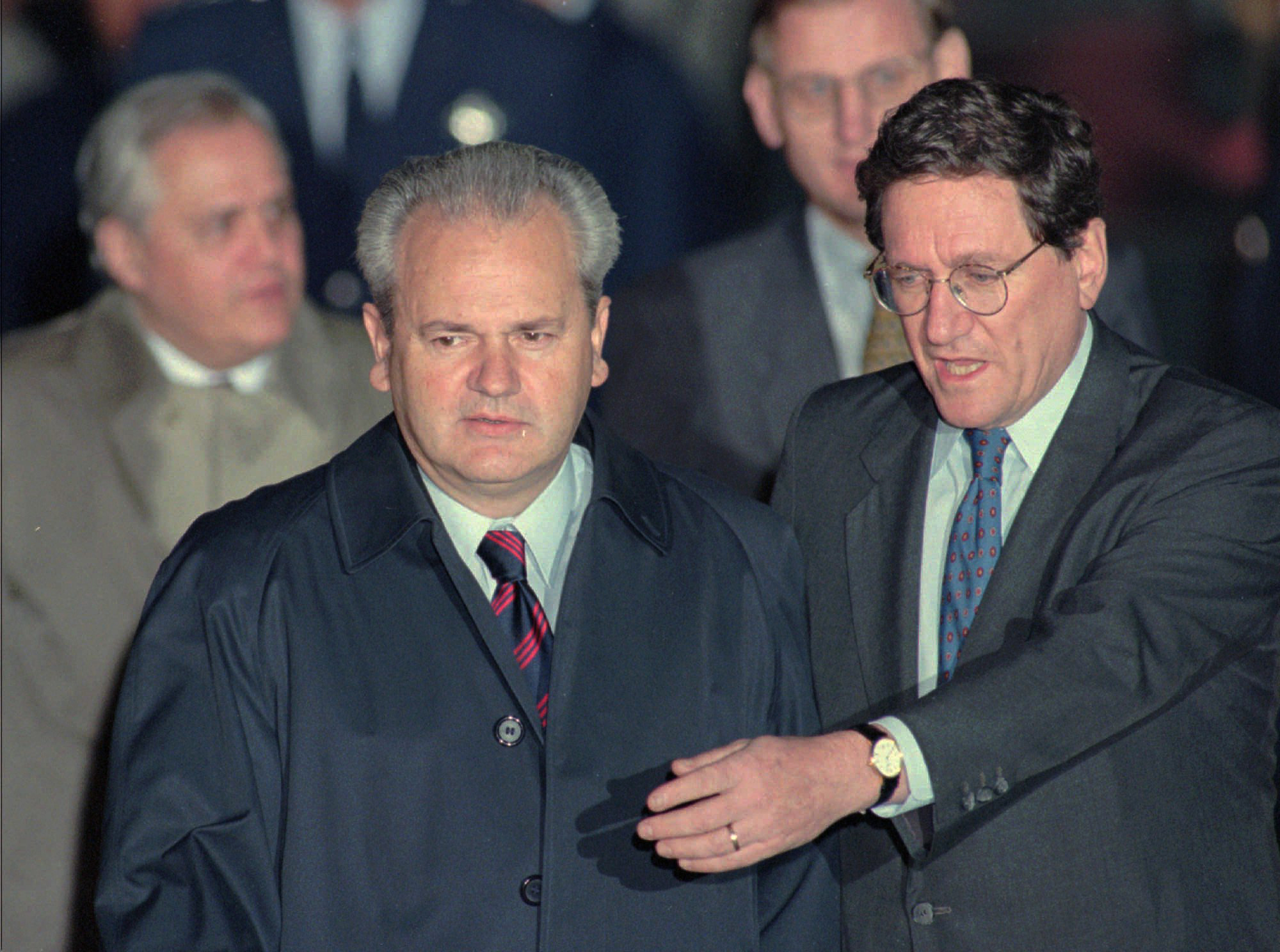 FILE - This Oct. 31, 1995 file photo shows Richard C. Holbrooke escorting Serbian President Slobodan Milosevic at Wright-Patterson Air Force Base in Dayton, Ohio, for the start of the Proximity Peace Talks. (AP Photo/Beth A. Keiser)