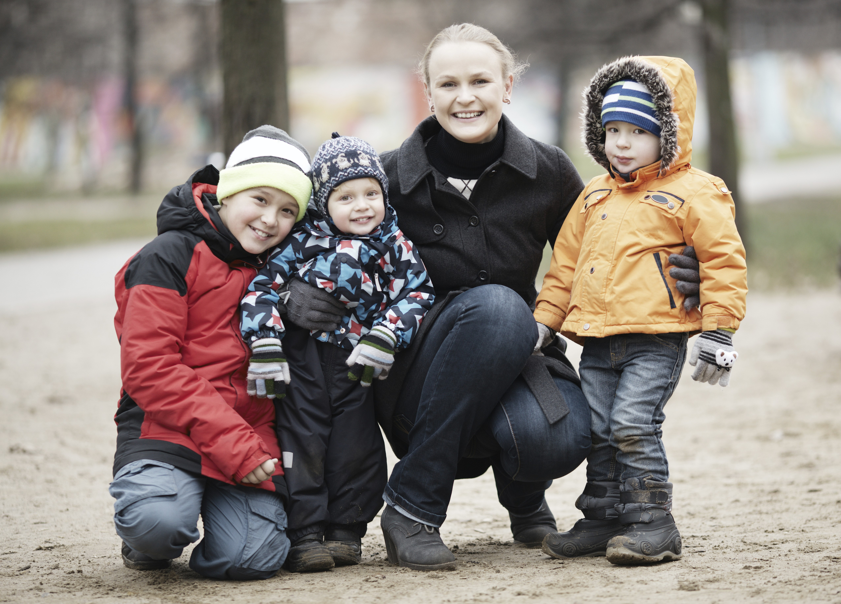 Happy attractive mother with her three young children posing outdoors together in their thick warm winter clothing,Image: 988463653, License: Royalty-free, Restrictions: , Model Release: yes, Credit line: Danil Roudenko / imageBROKER / Profimedia
