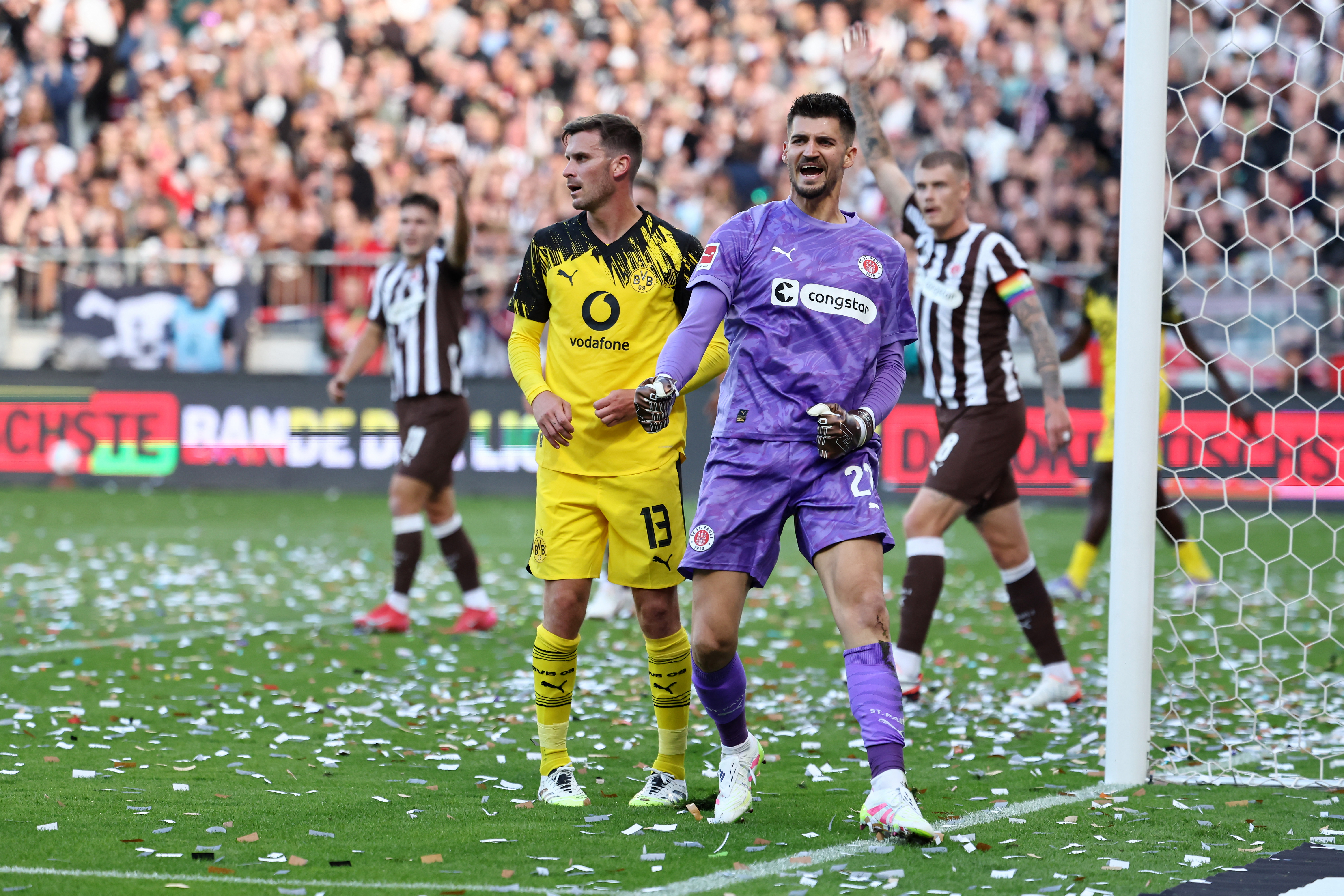 Dortmund's German midfielder #13 Pascal Gross (L) reacts next to St Pauli's Bosnian goalkeeper #22 Nikola Vasilj during the German first division Bundesliga football match between FC St Pauli and Borussia Dortmund in Hamburg, northern Germany on August 23