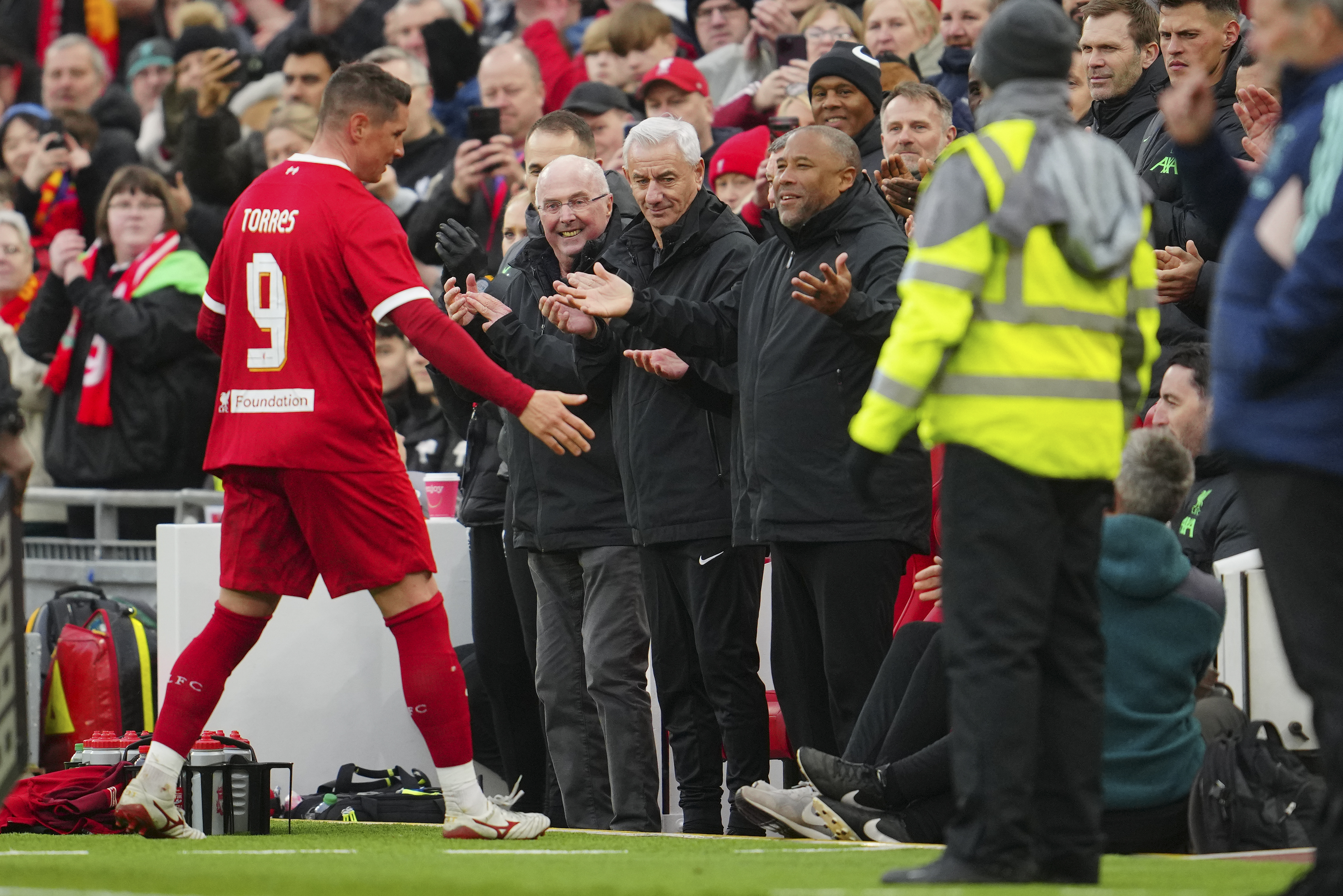 Liverpool legends Fernando Torres is greeted by former England manager Sven-Goran Eriksson, Ian Rush and John Barnes during an exhibition soccer match between Liverpool Legends and Ajax Legends at Anfield Stadium, Liverpool, England, Saturday March 23, 20