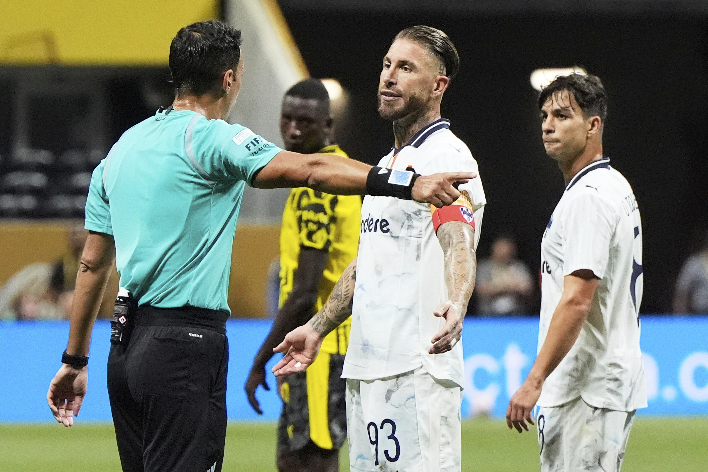 Monterrey's Sergio Ramos reacts as he speaks to referee Facundo Tello, left, during the Club World Cup round of 16 soccer match between Borussia Dortmund and CF Monterrey in Atlanta, Tuesday, July 1, 2025. (AP Photo/Mike Stewart)