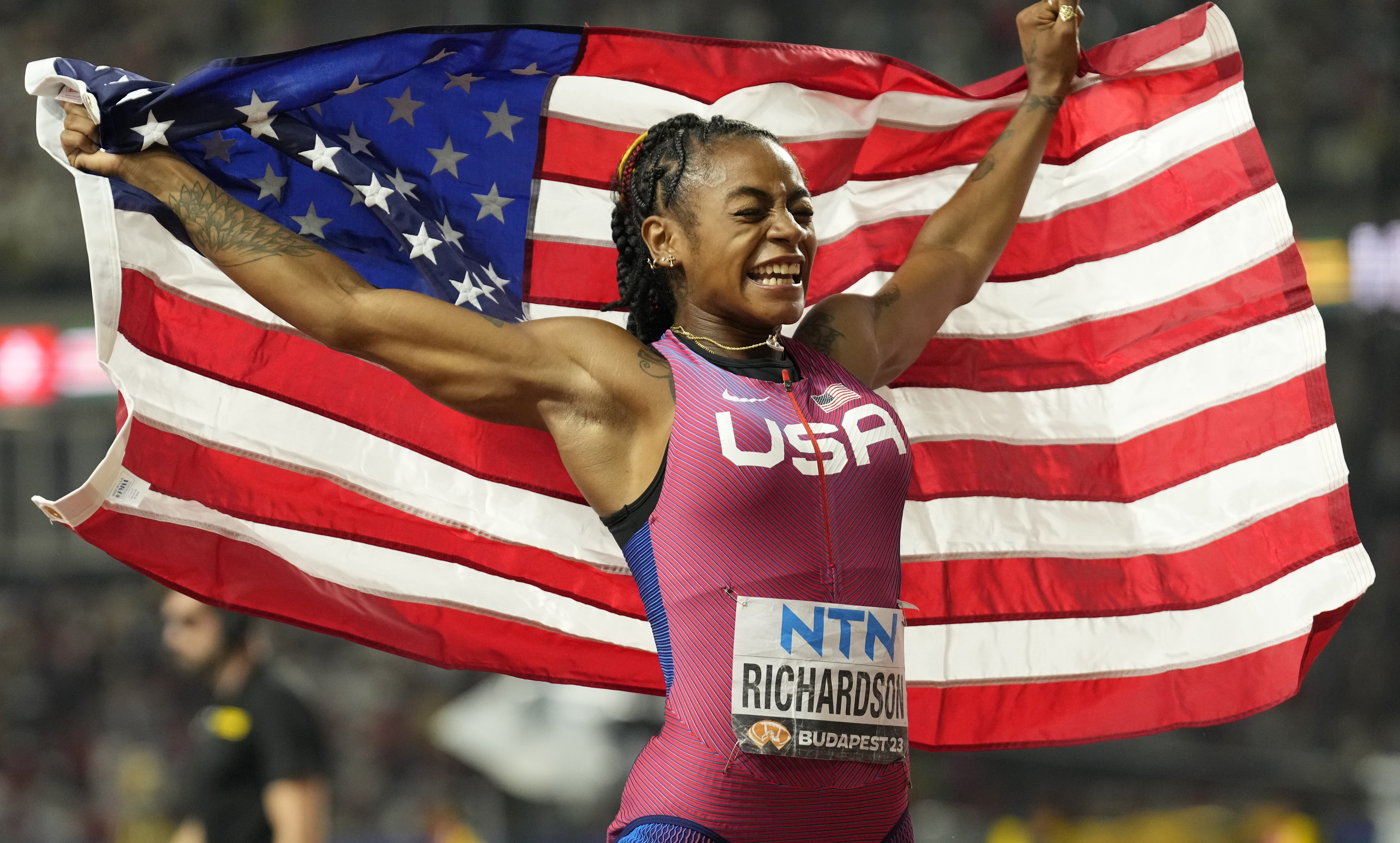 Sha'Carri Richardson, of the United States, celebrates winning the women's 100 meters during the World Athletics Championships in Budapest, Hungary, Monday, Aug. 21, 2023. (AP Photo/Ashley Landis)