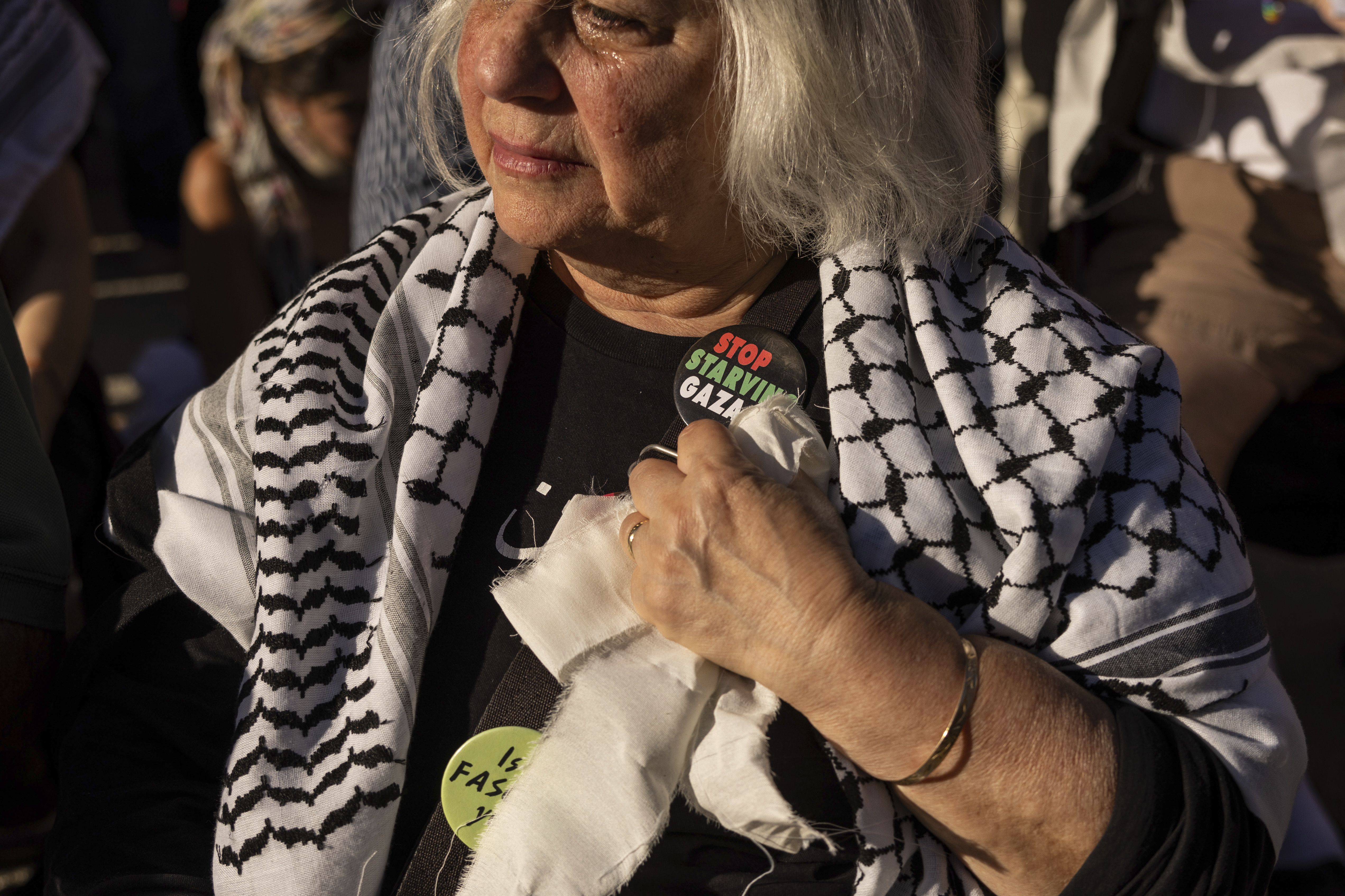 A person wearing a pin reading ""Stop Starving Gaza" attends Yizkor, a Jewish prayer service for the dead, to demand a permanent cease-fire in Gaza, on Yom Kippur in the Brooklyn borough of New York, Saturday, Oct. 12, 2024. (AP Photo/Yuki Iwamura)