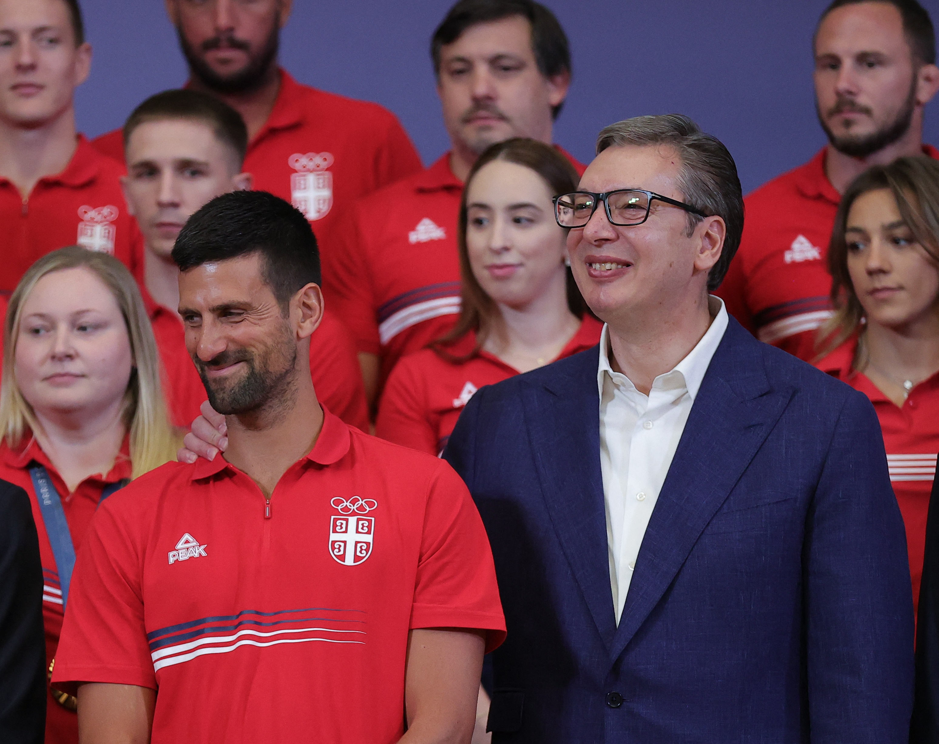 Serbian President Aleksandar Vucic (R) greets tennis gold medallist Novak Djokovic in Belgrade on August 12, 2024, after returning from the Paris 2024 Olympics Games. (Photo by PEDJA MILOSAVLJEVIC / AFP)