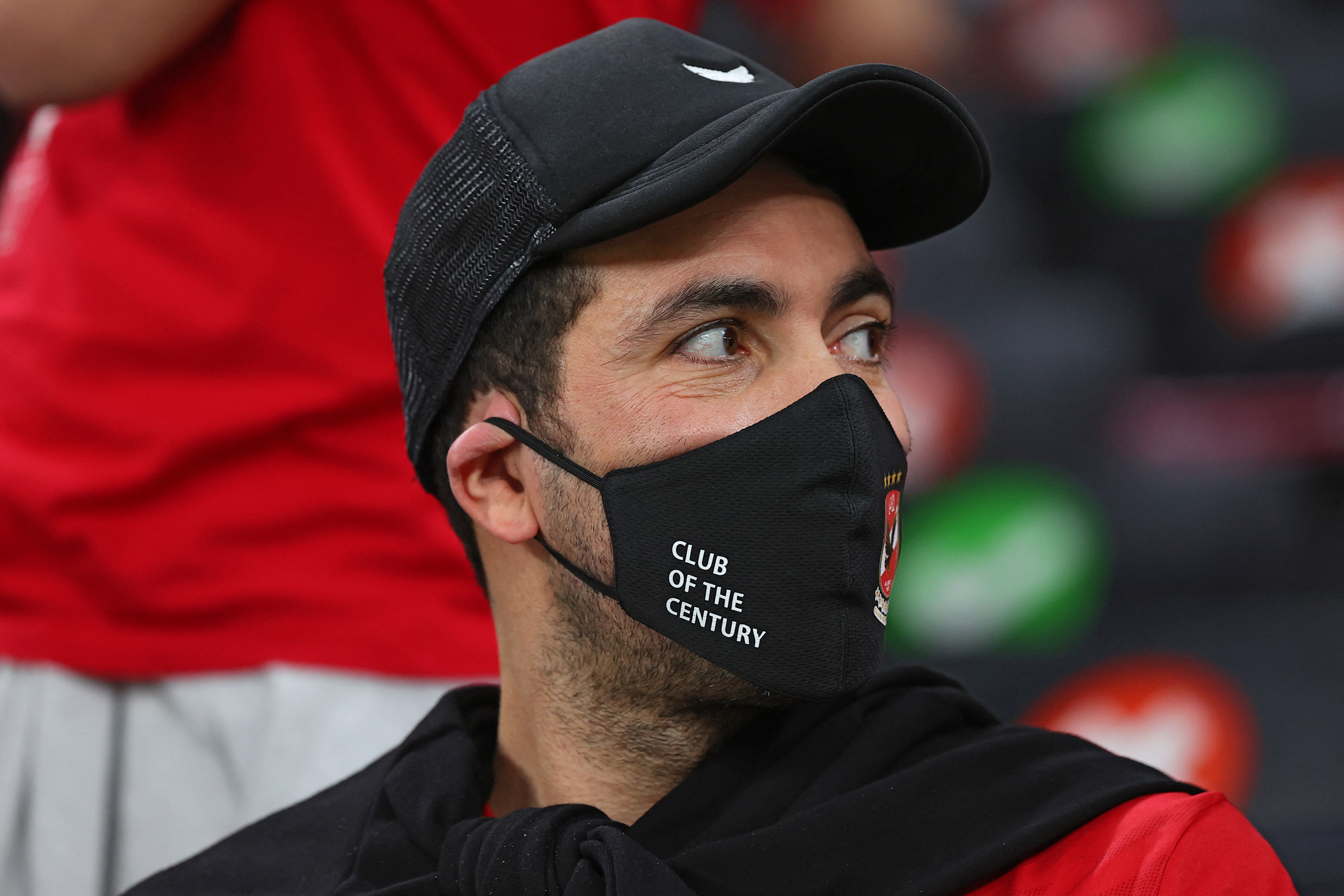 Retired Egyptian footballer Mohamed Aboutrika sits with Ahly supporters