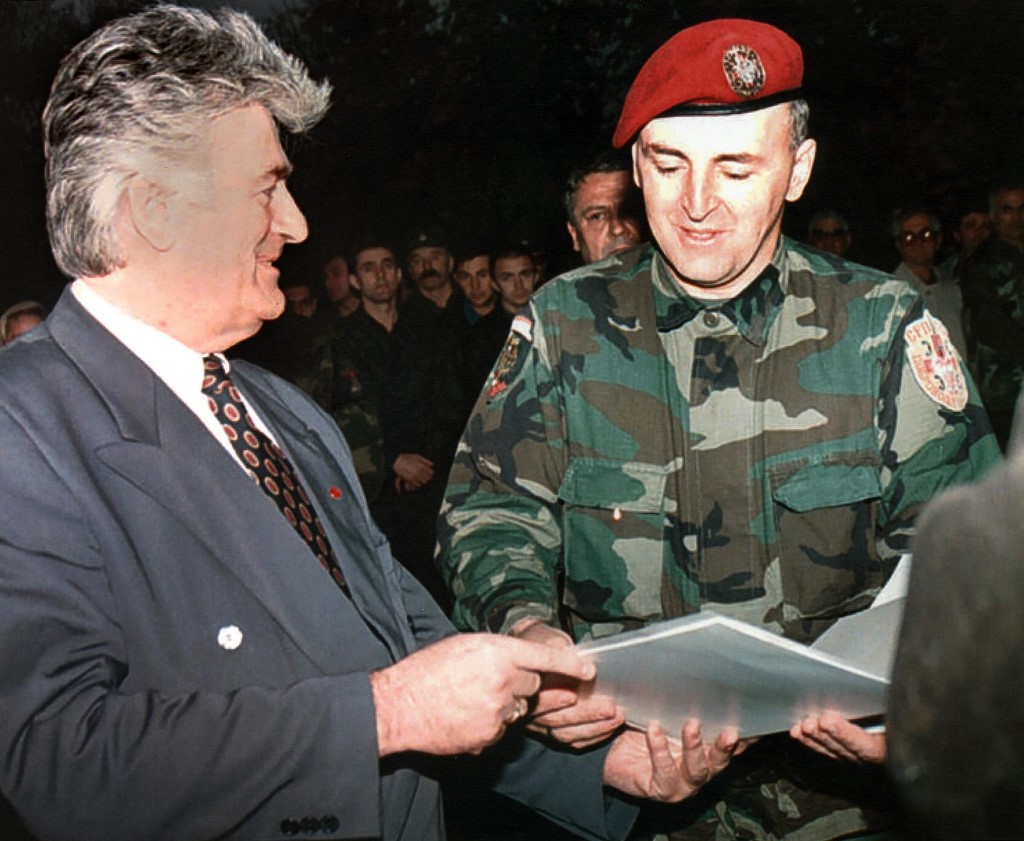 Bosnian Serbe leader Radovan Karadzic (L) hands over a certificate of graduation to Zeljko "Arkan" Raznatovic (R),