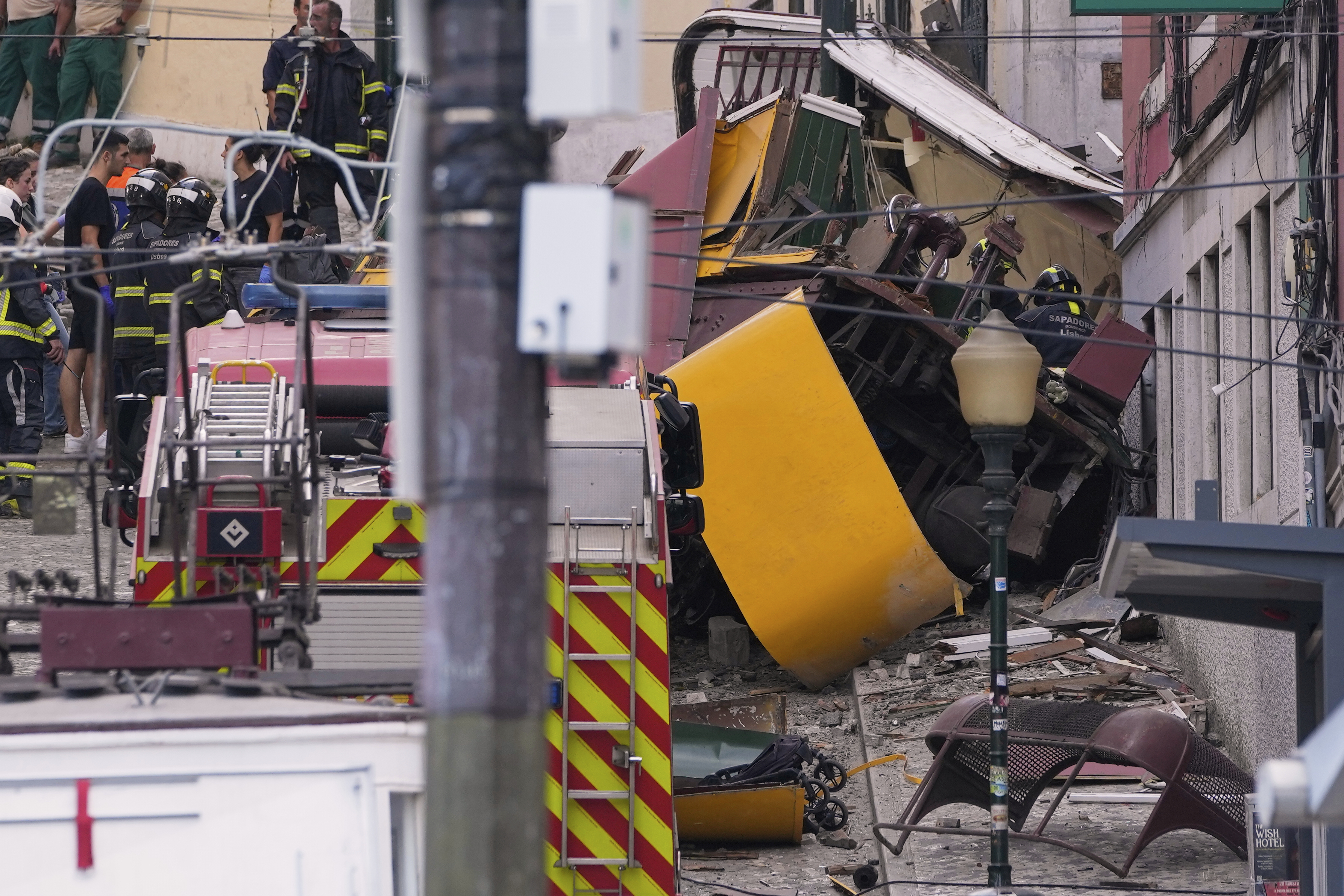 Emergency teams work at the site of a derailed electric streetcar in Lisbon, Portugal, Wednesday, Sept. 3, 2025. (AP Photo/Armando Franca)
